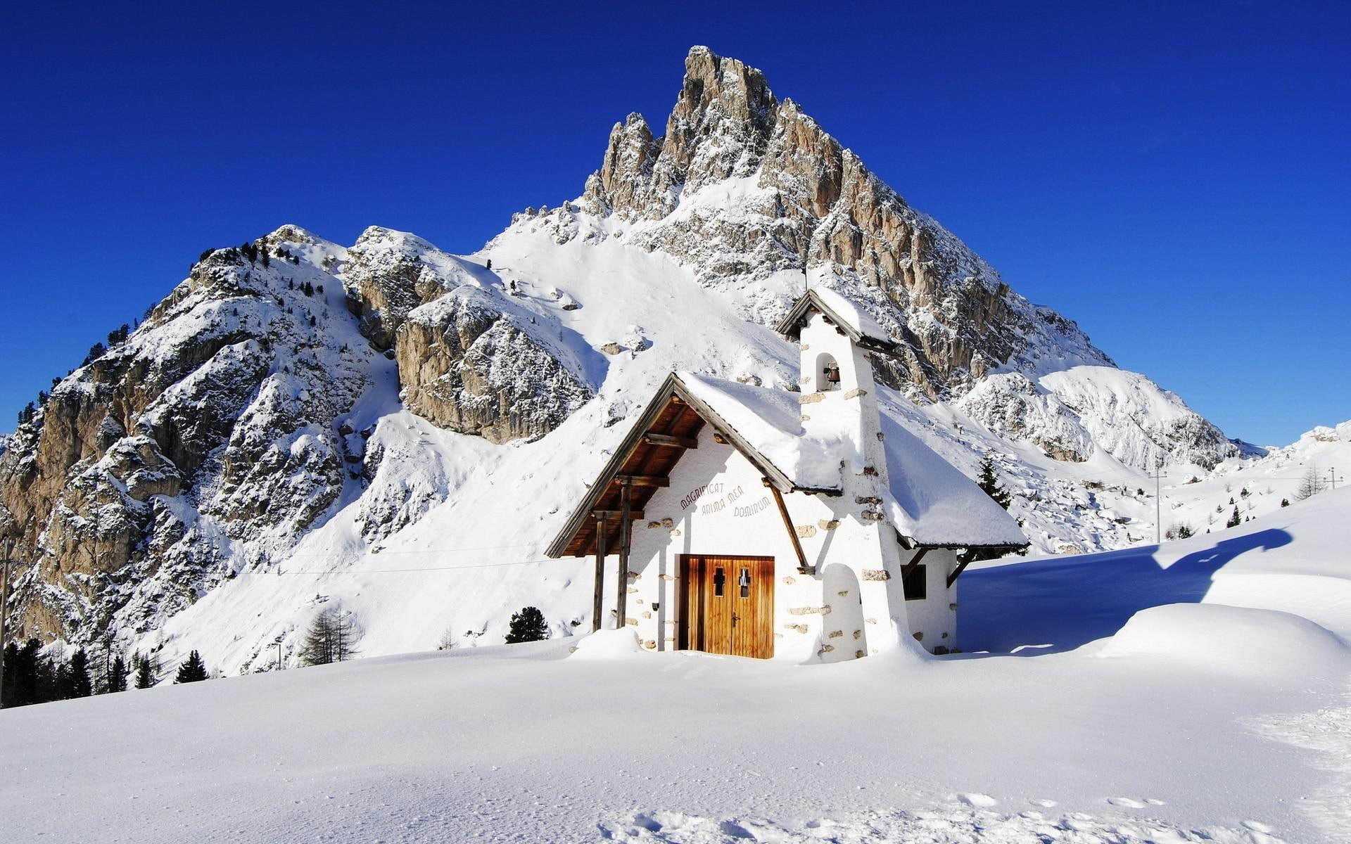 Falzarego Pass, Italy, concrete house on mountain covered in snow