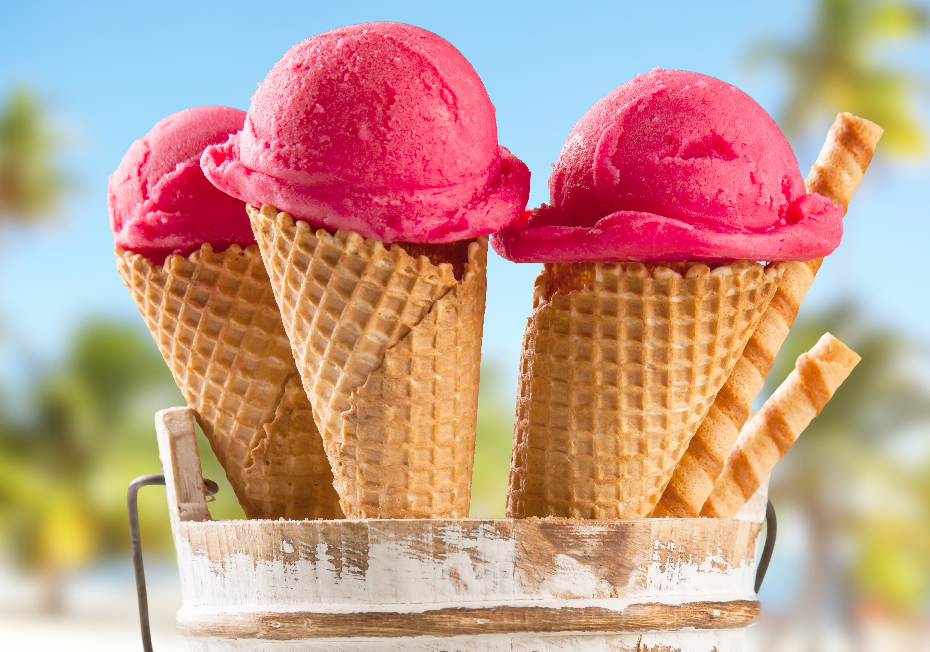 three scoops of strawberry ice creams, sticks, horn, raspberry ice cream