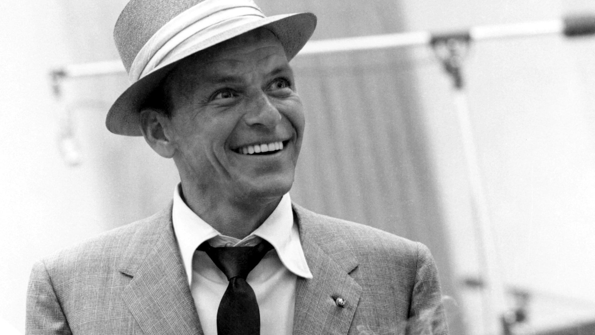 man wearing suit jacket and hat photo, frank sinatra, smile, tie