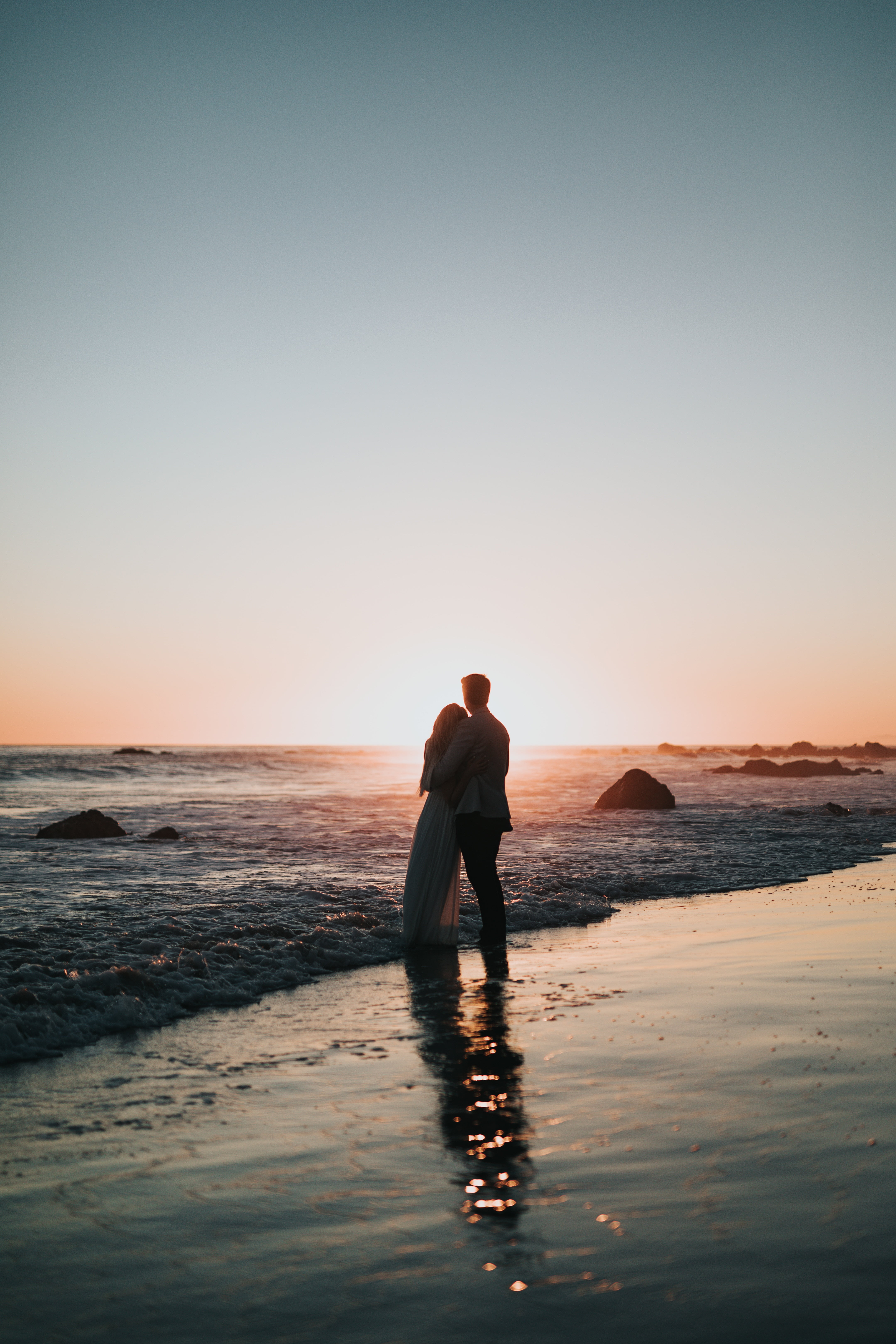 men's black dress suit, couple, beach, sunset, hugs, love, sea