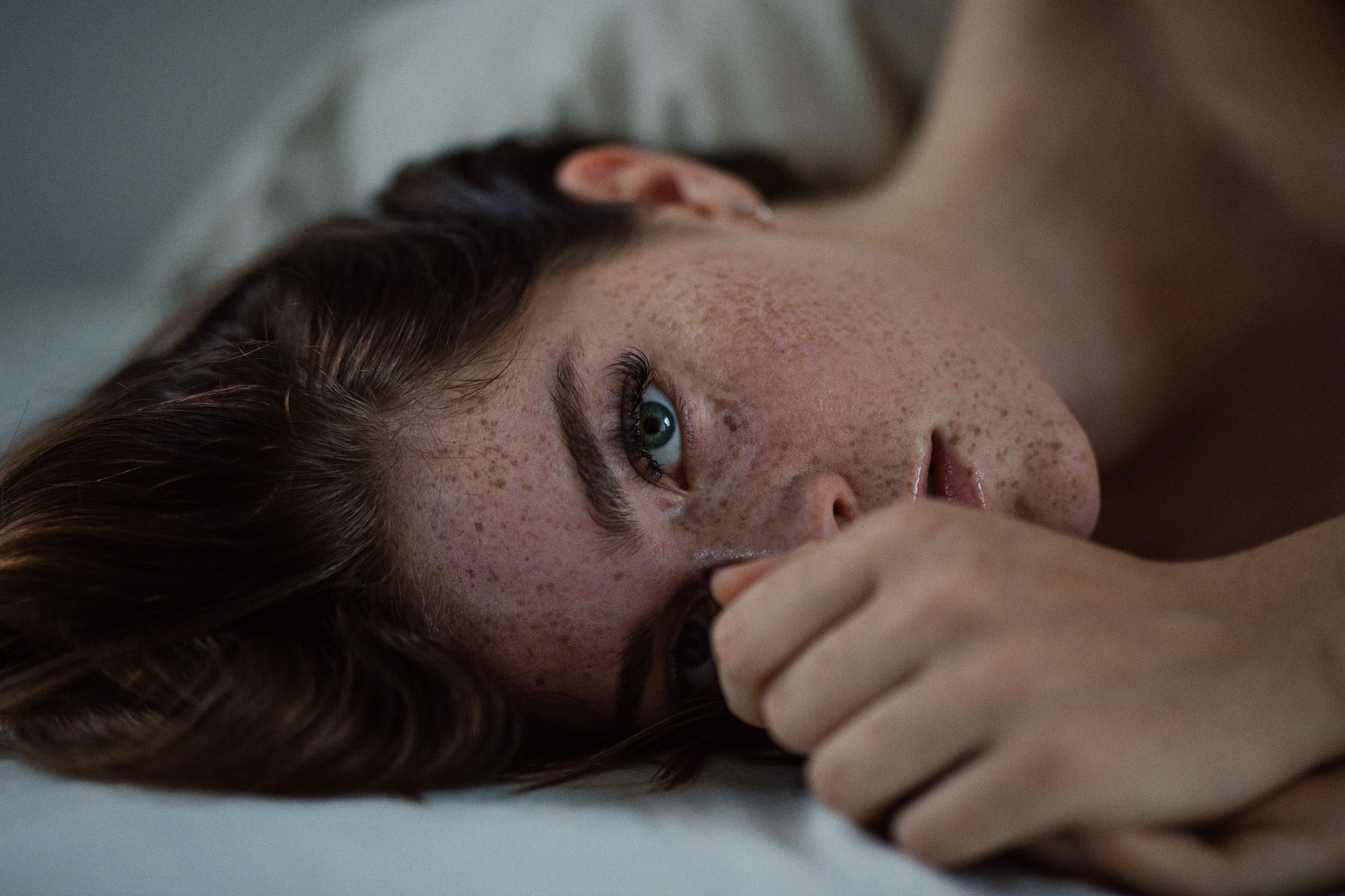 Jesse Herzog, women, brunette, lying on side, freckles, face