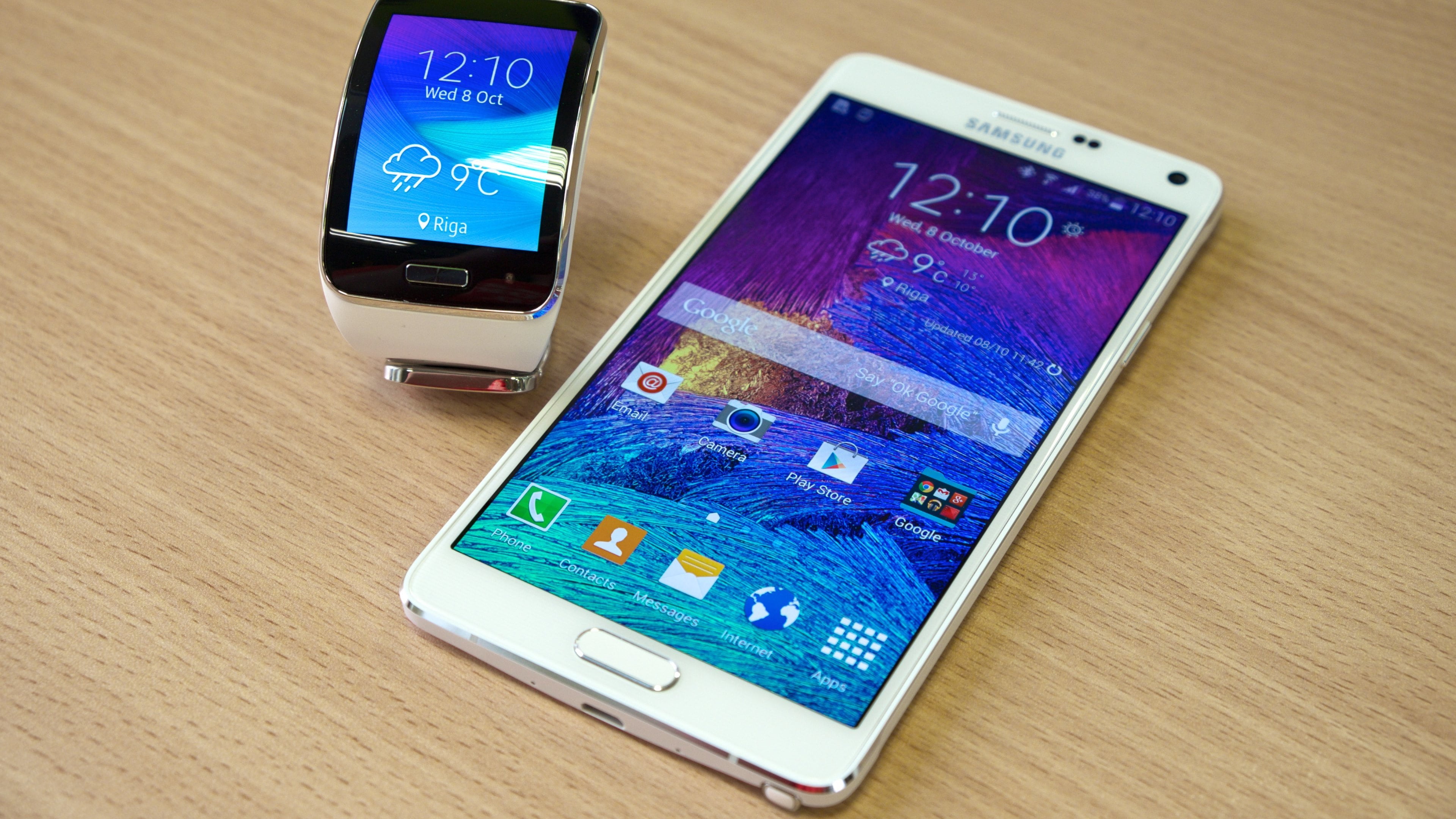 white Samsung Galaxy Android smartphone and Samsung Gear S, SmartPad
