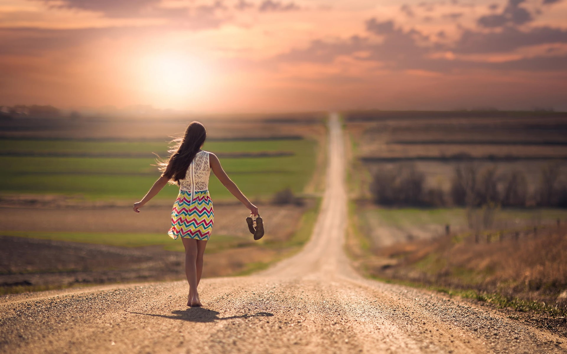 Girl walking in the road, sunset