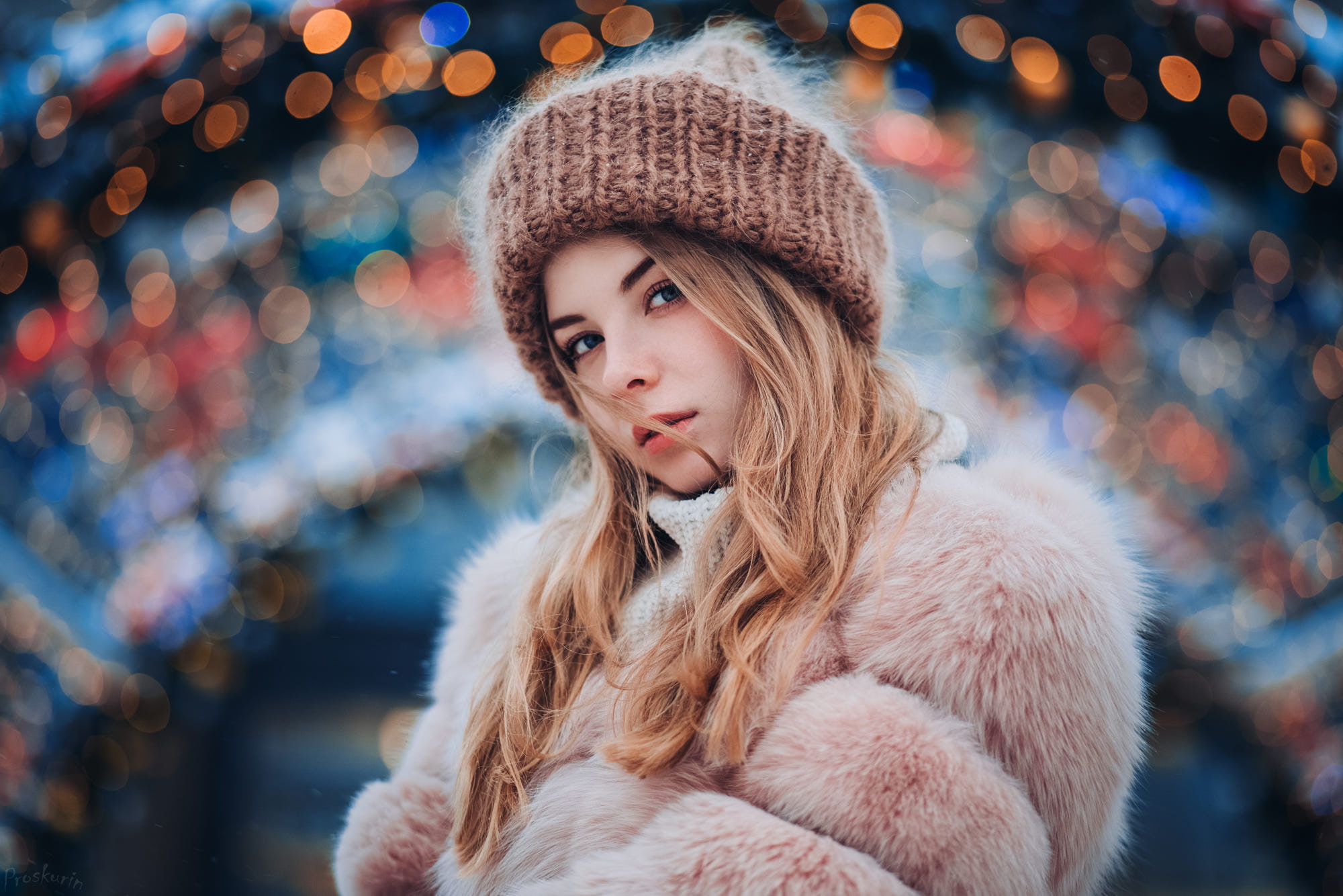 portrait, bokeh, pink coat, hair in face, looking at viewer