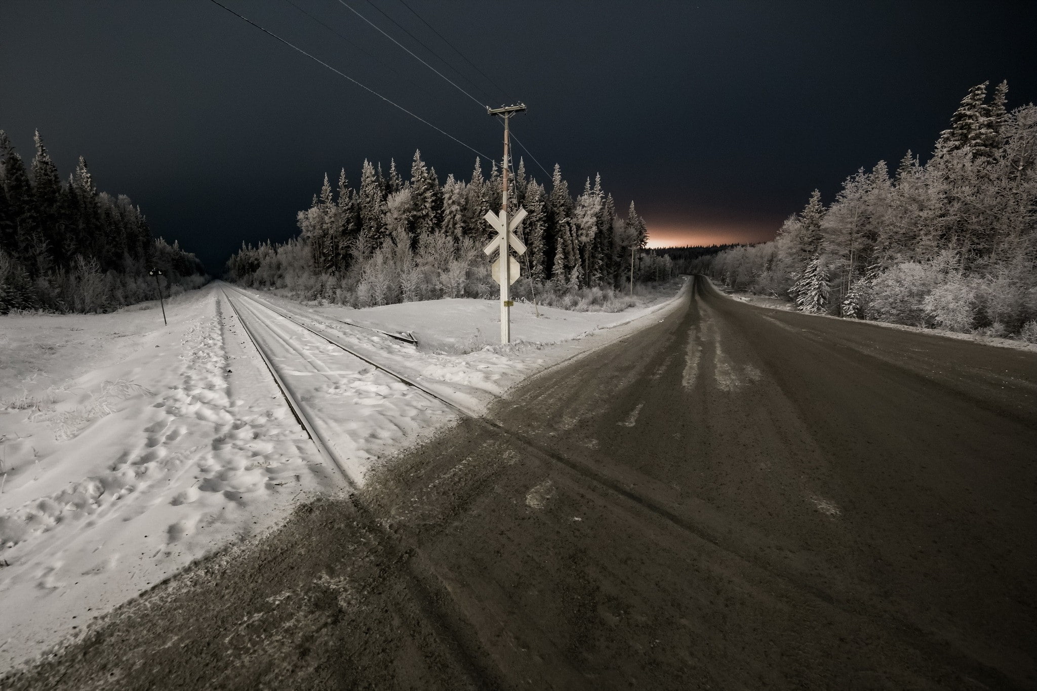 railway crossing night landscape road snow trees