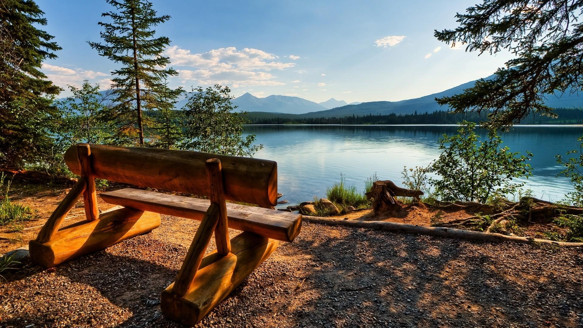 Seat By The Lake, wooden bench in front of sea and mountain view photography