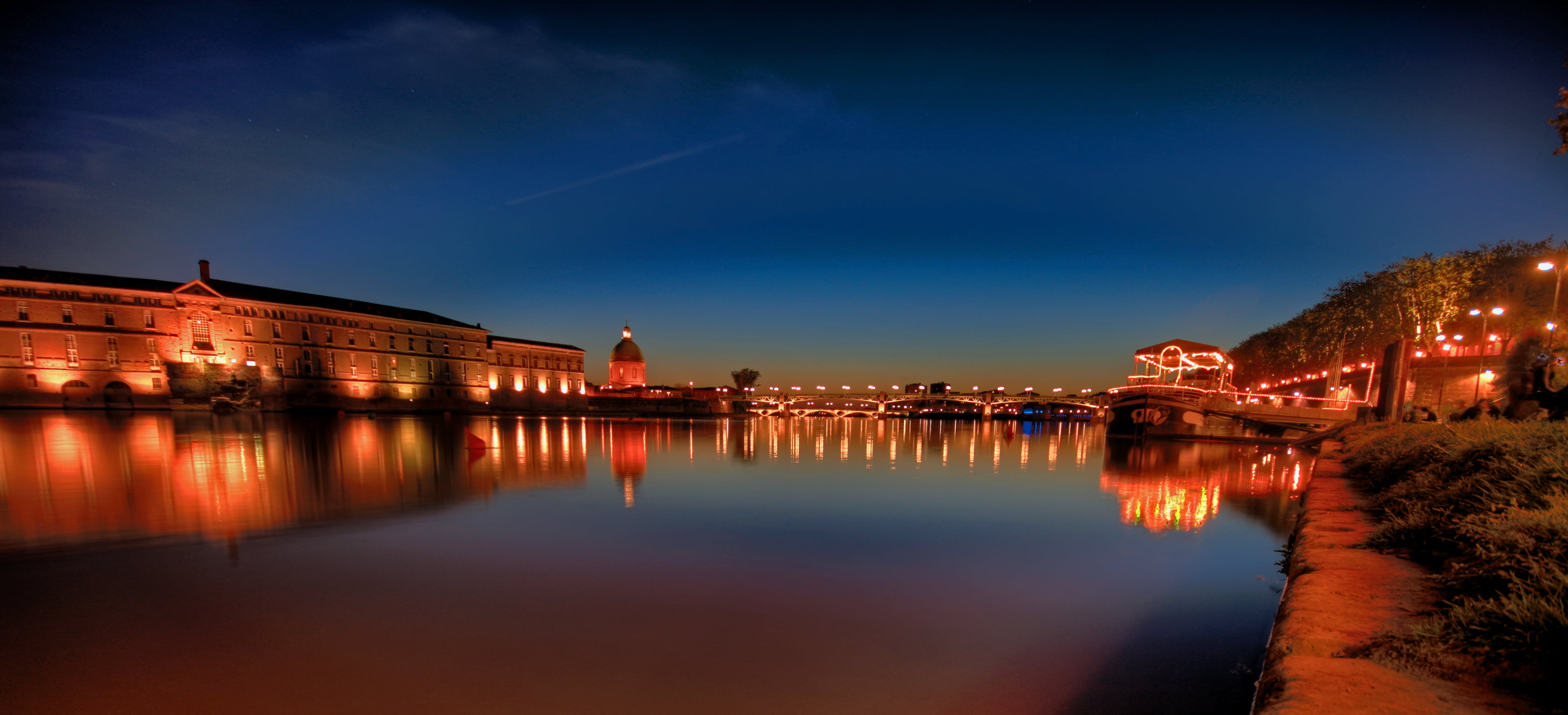 reflection of lighted city buildings on body of water during nighttime, garonne, garonne