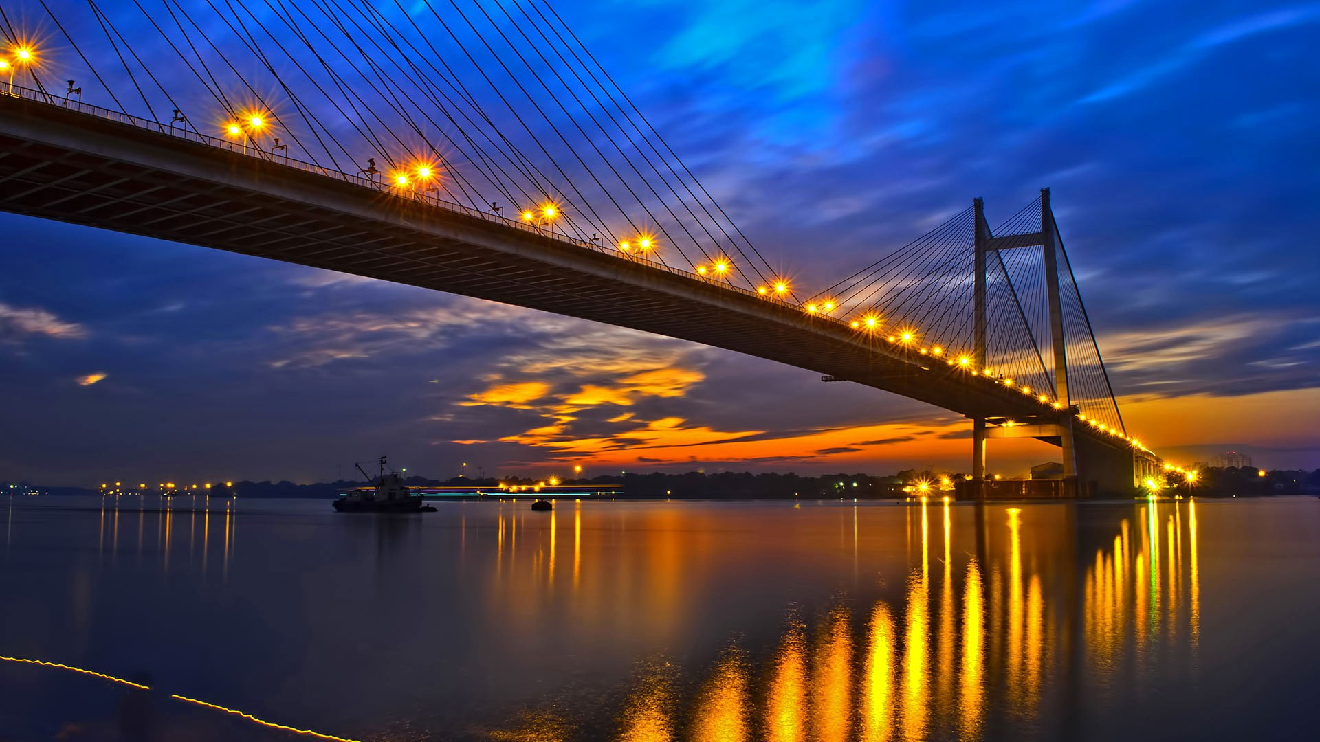 Hooghly Bridge, river, concrete bridge under blue sky, evening