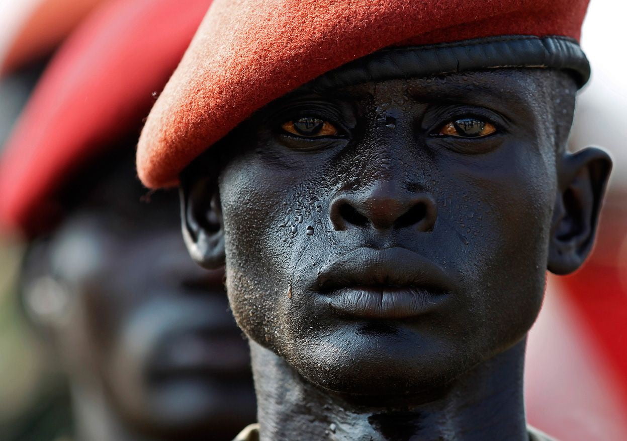 man wearing red hat, South Sudan, soldier, close-up, portrait