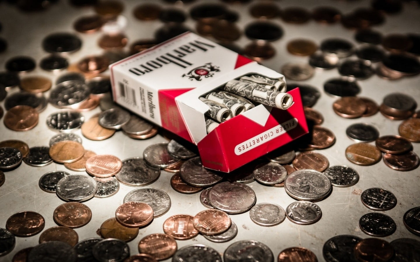 Marlboro cigarette box, cigarettes, money, dollars, coins, wealth