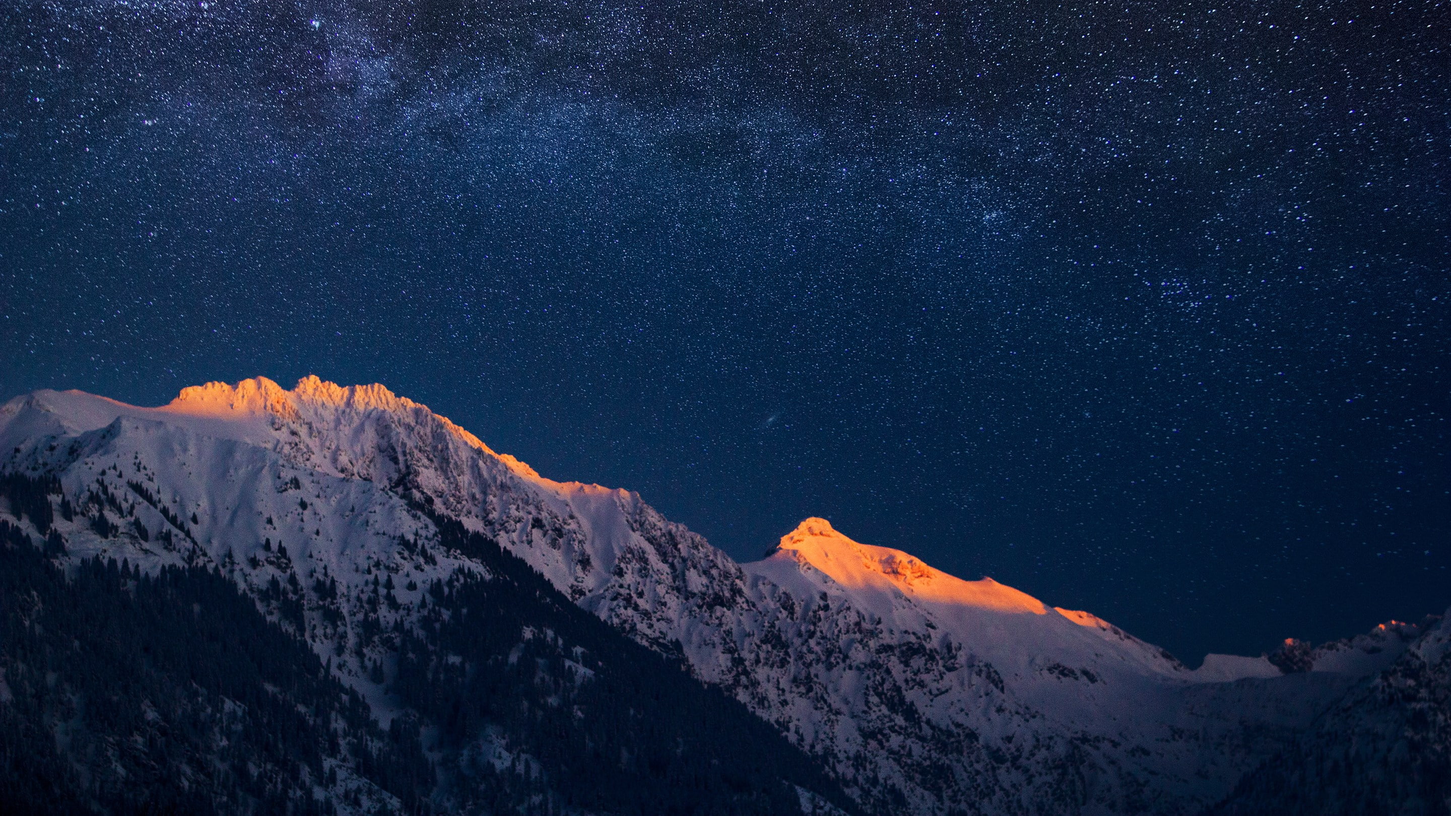 snowy mountains at night with starry sky, beauty in nature