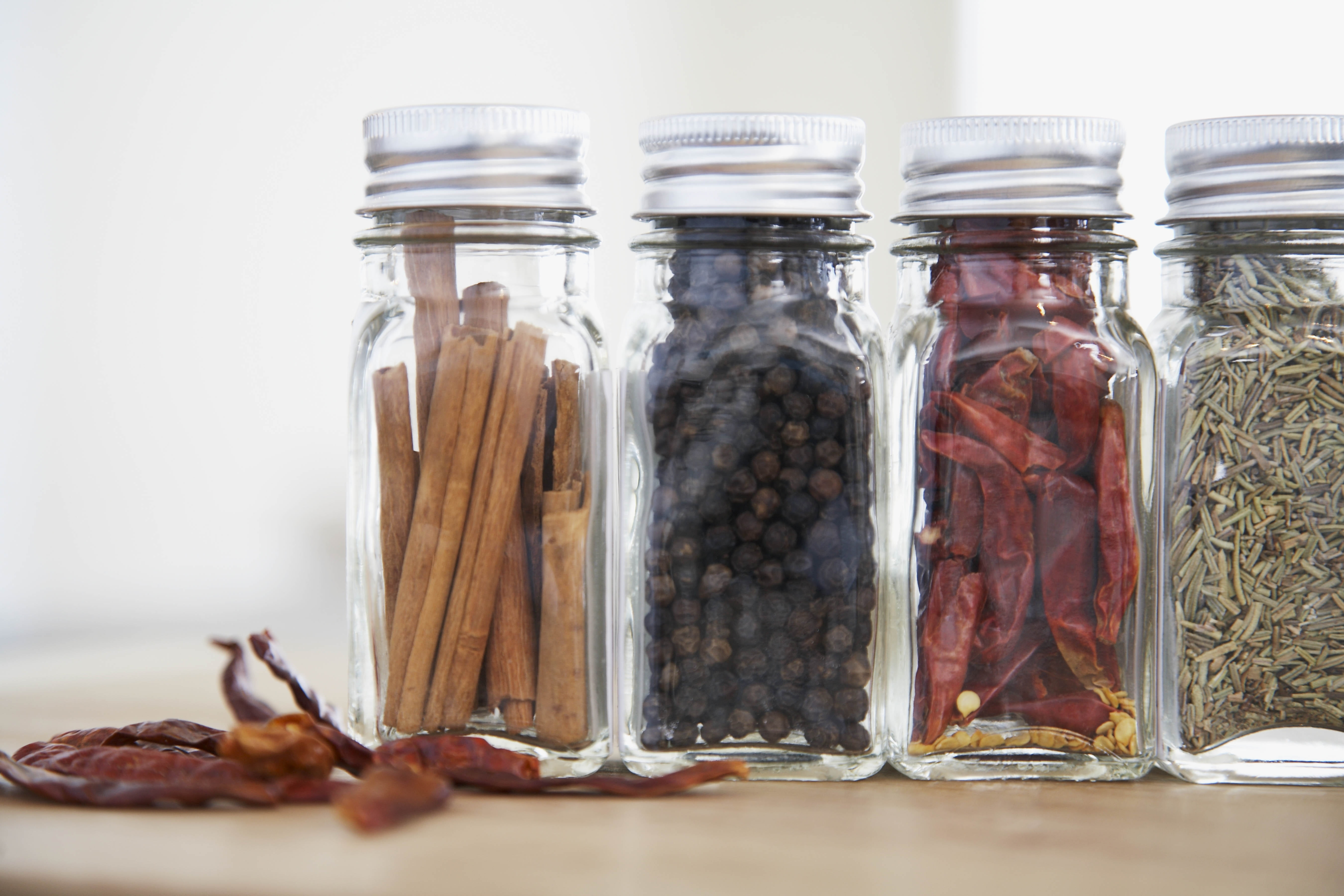 three clear glass spice bottles, banks, spices, seasonings, pepper