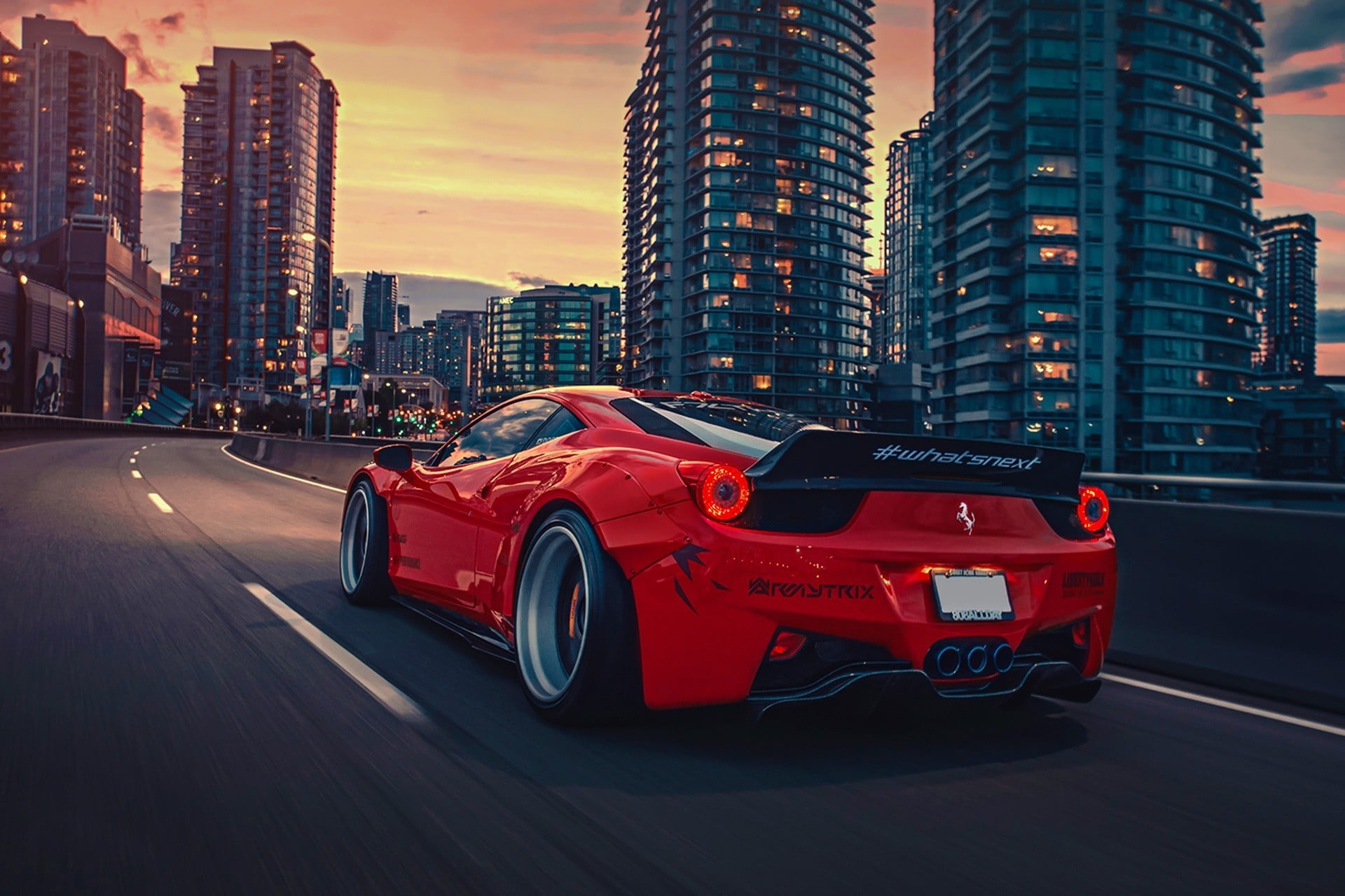 red Ferrari sports coupe traveling on road towards building digital wallpaper