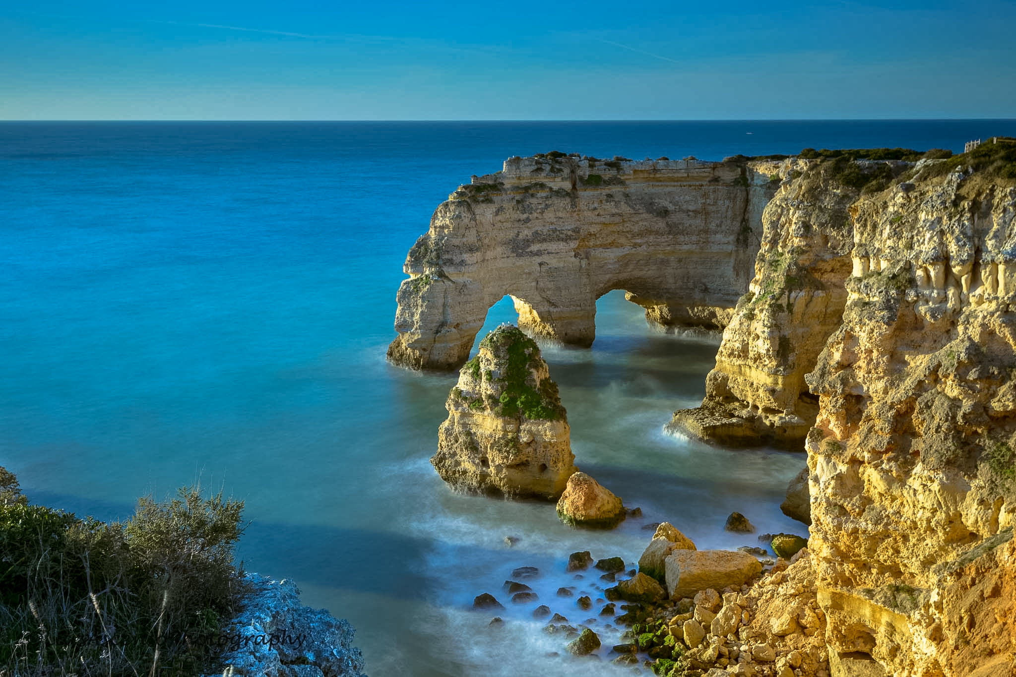 aerial view of rock formation and cliff beside blue ocean, algarve, algarve