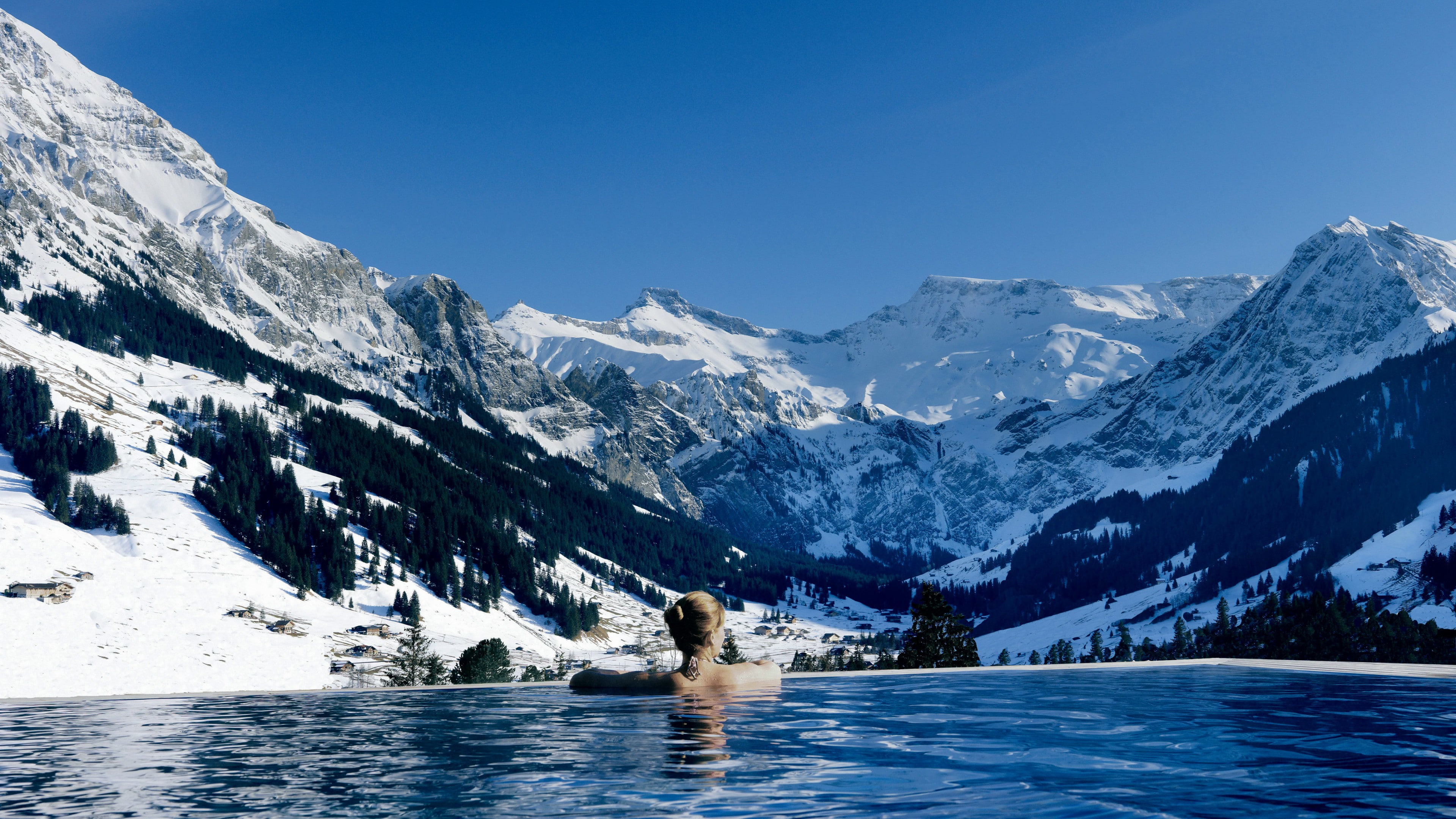woman on swimming pool in front of snow covered mountain, Cambrian hotel
