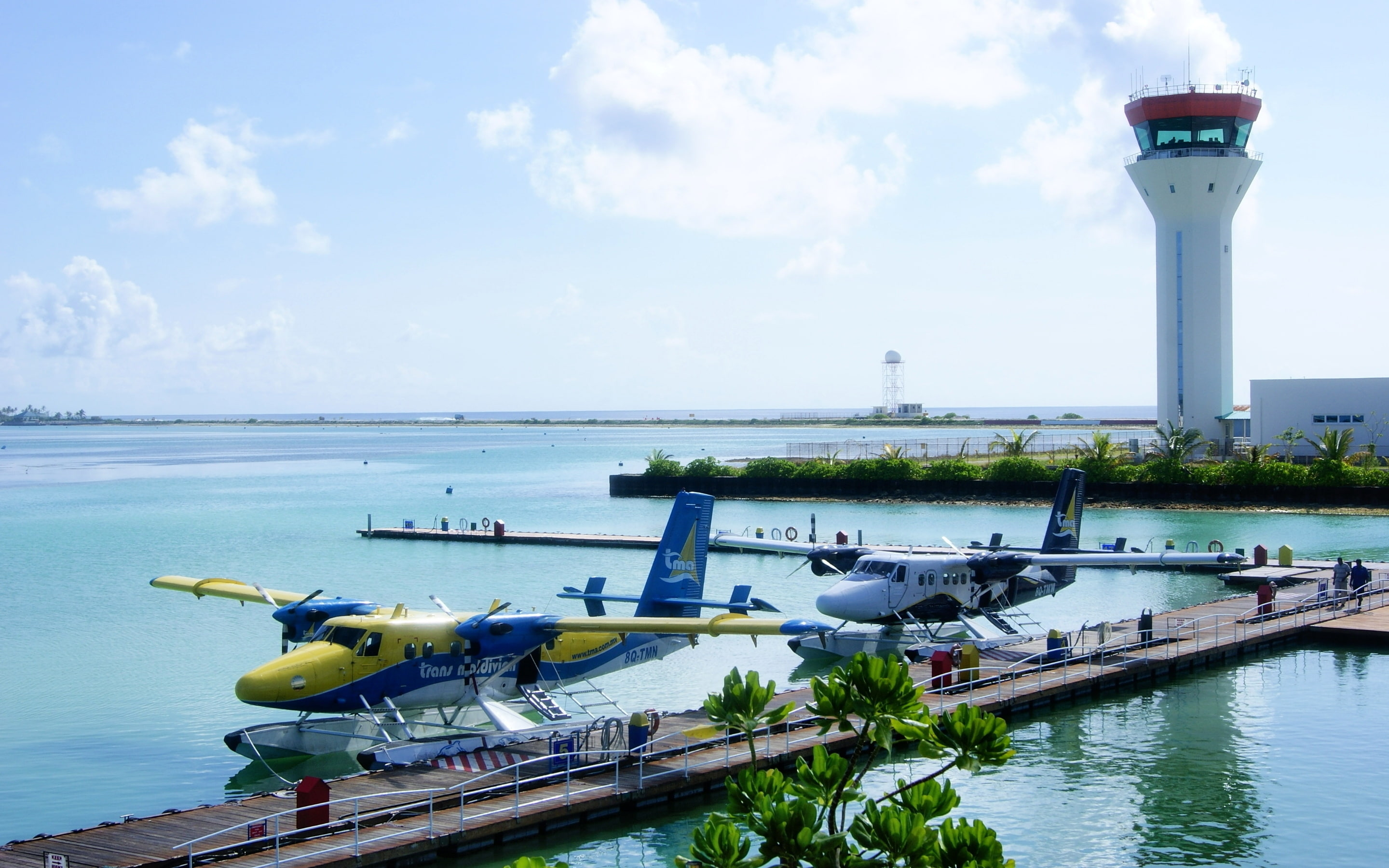 Maldives Airport, aircraft docked on water bay during day time