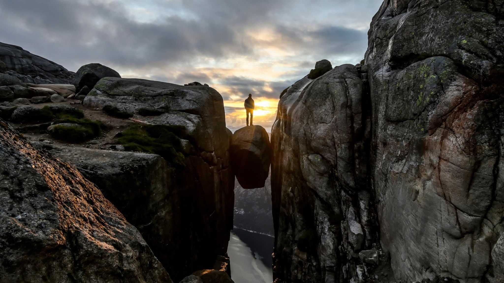 person standing on rock in the middle of cliff wallpaper, men
