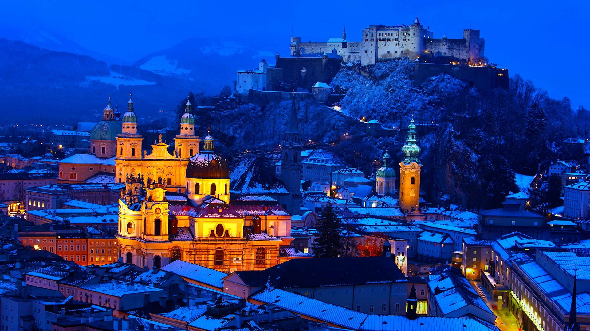 architecture building old building town house salzburg austria winter snow evening lights church cathedral castle hill rock rooftops ancient