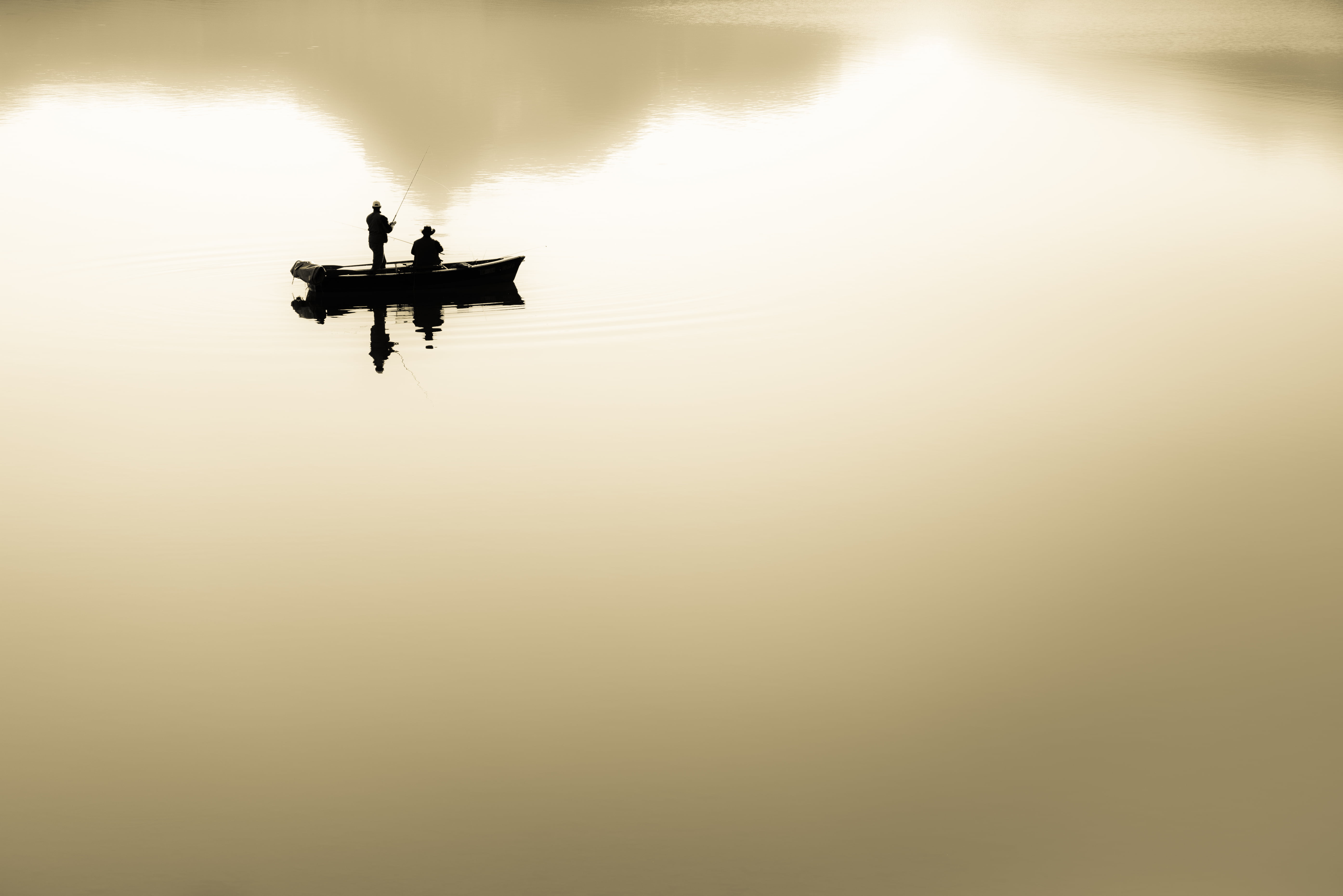silhouette of two people in boat fishing during daytime, Melchsee-Frutt