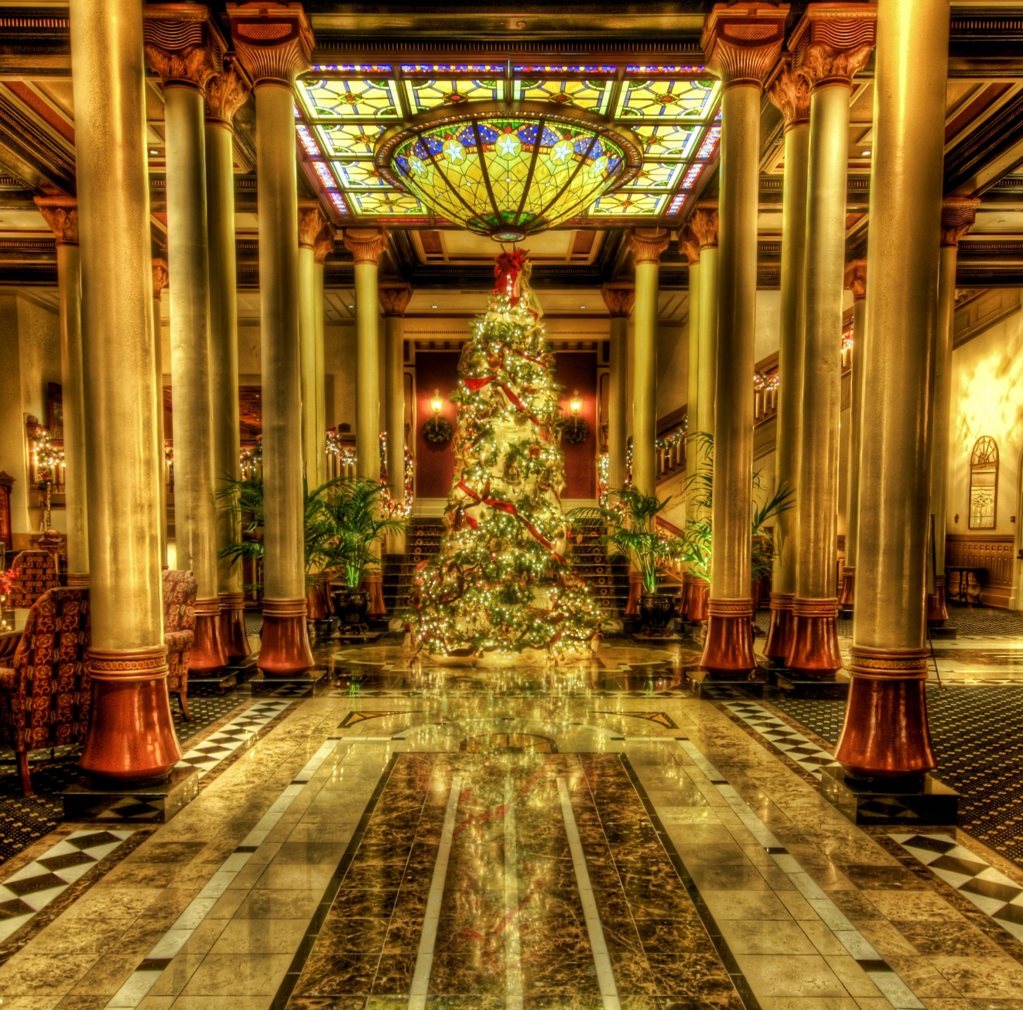 Christmas - Driskill Hotel Lobby, Texas, green and red Christmas tree with yellow string lights