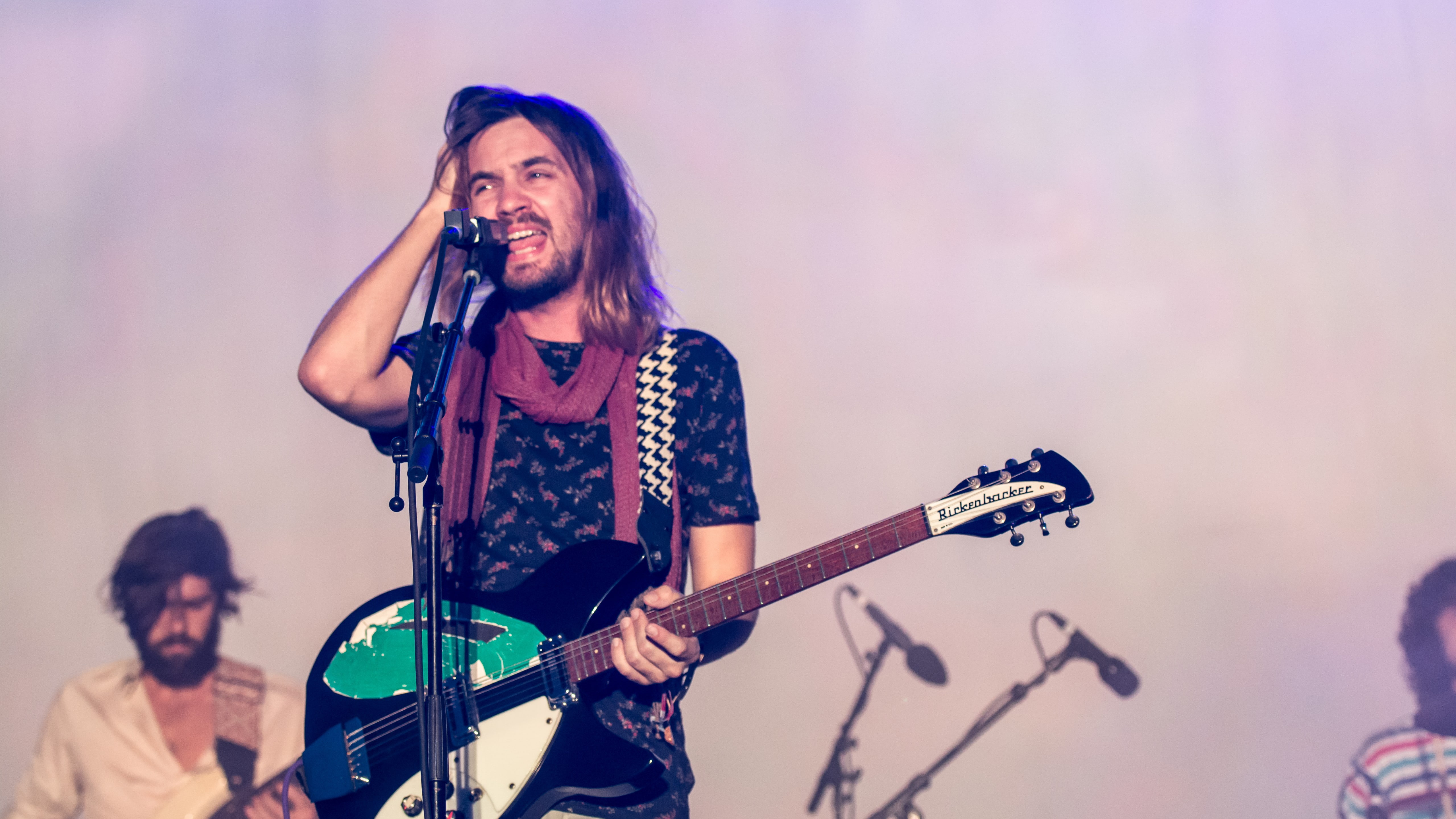 man wearing black t-shirt white holding guitar, Tame Impala, Top music artist and bands