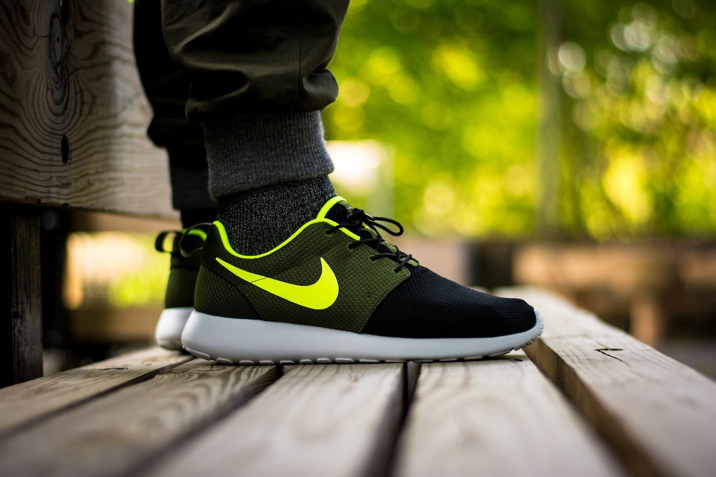 pair of black-yellow-and-white Nike Roshe Run sneakers, low section