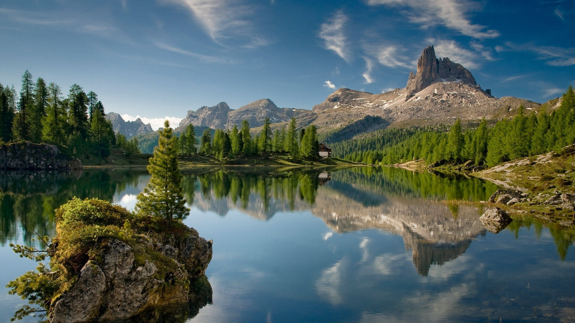clear calm body of water surrounded by trees, lake, rock, mountains