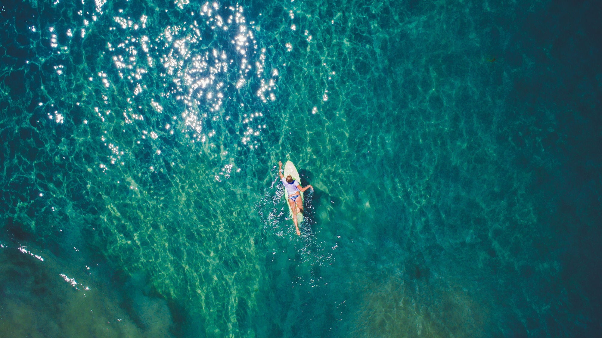 aerial photography of woman on yellow surfboard at sea, nature
