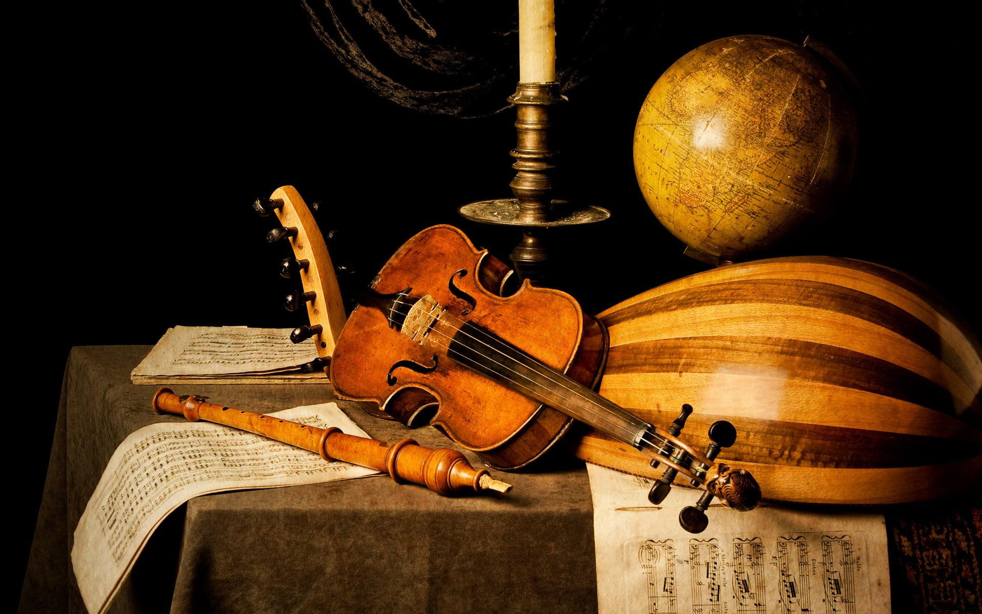 Vintage musical instruments, brown violin, brown baglama, desk globe and candle stick
