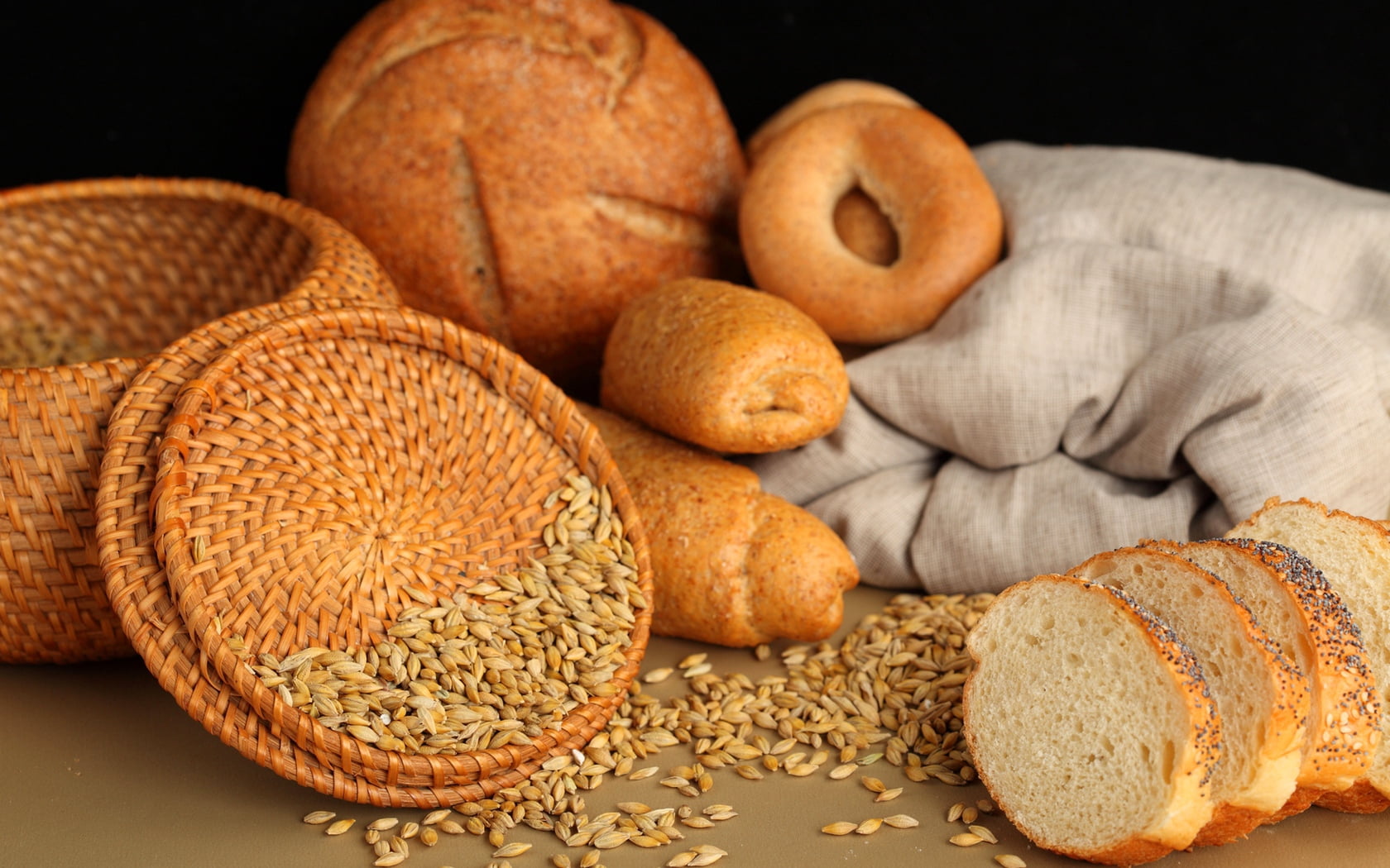 brown wicker bread basket, pastries, muffins, bagels, cereals