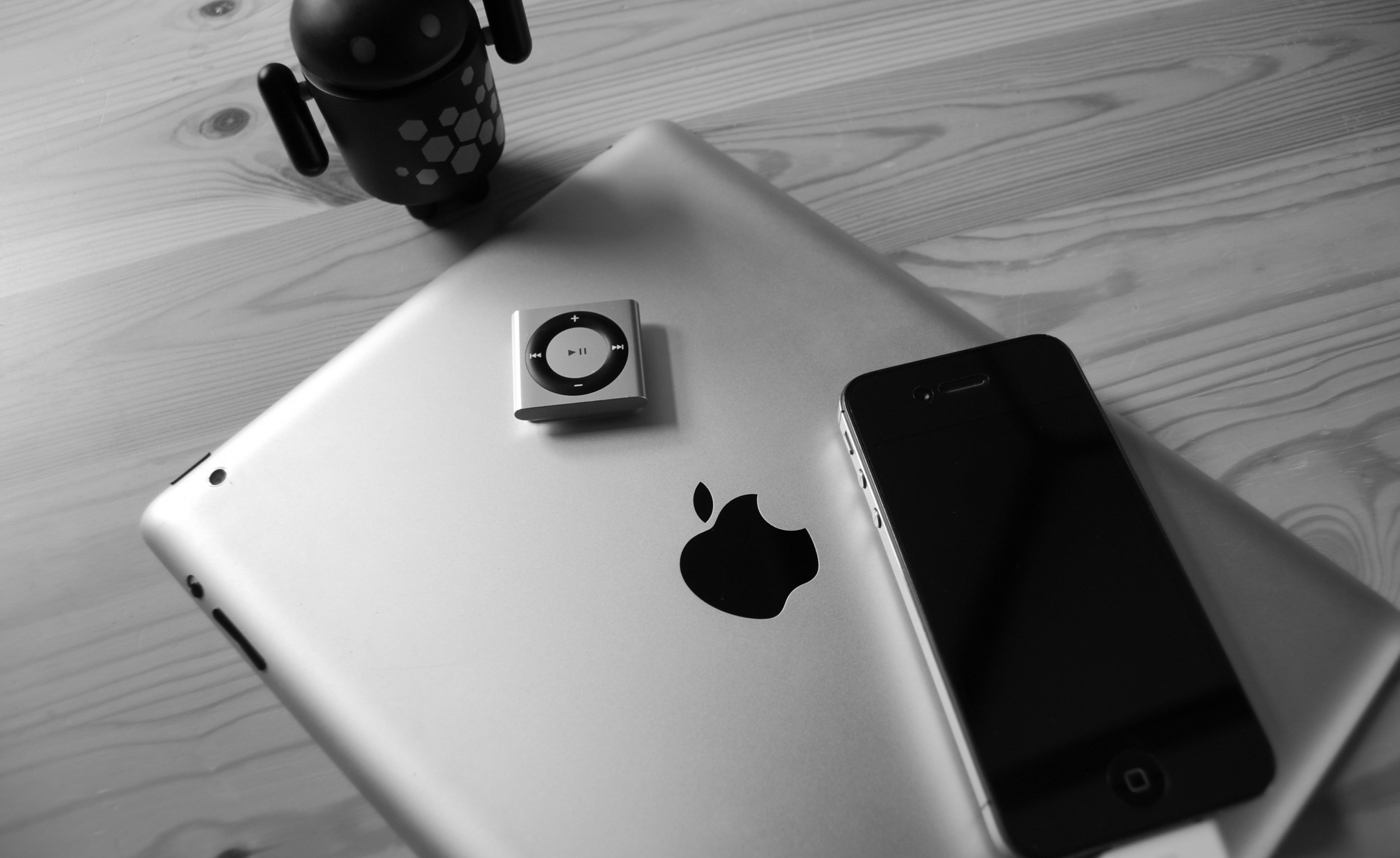 black iPhone 4, space gray iPad 3, and gray iPod shuffle, apple