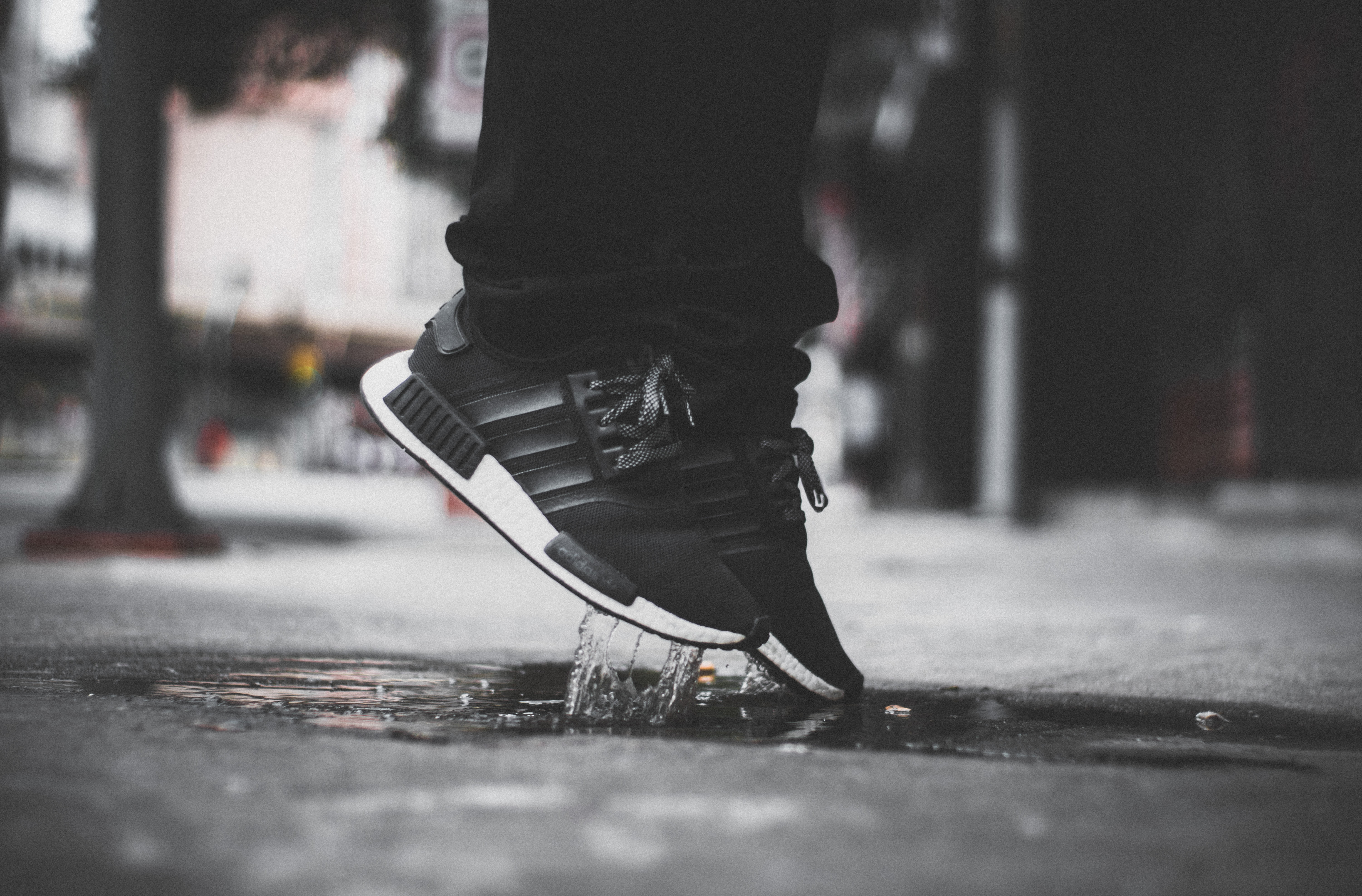 pair of black adidas NMD R1's, shoes, feet, outdoors, urban Scene