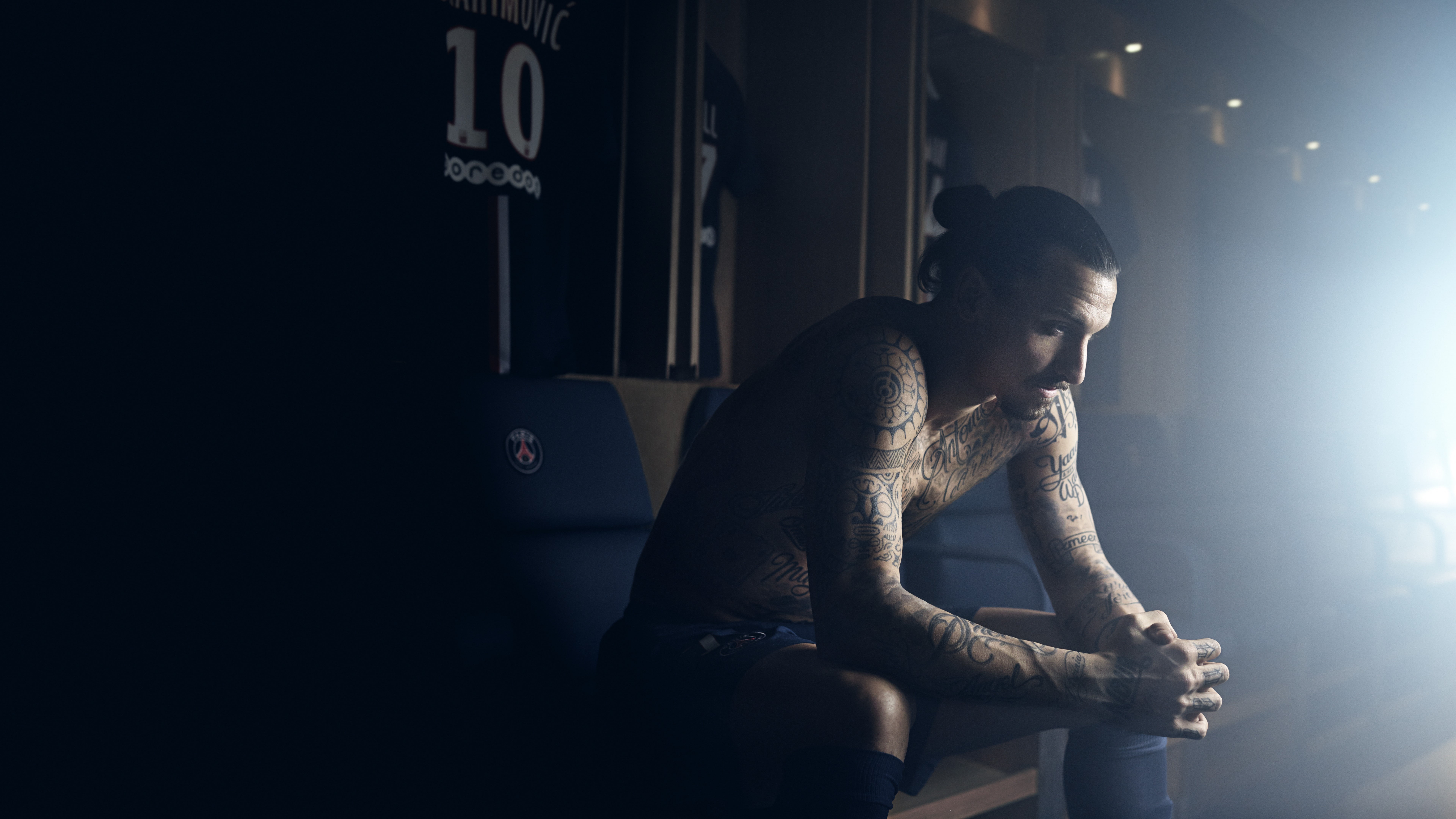 topless man sit on blue chair inside well lit room, Football