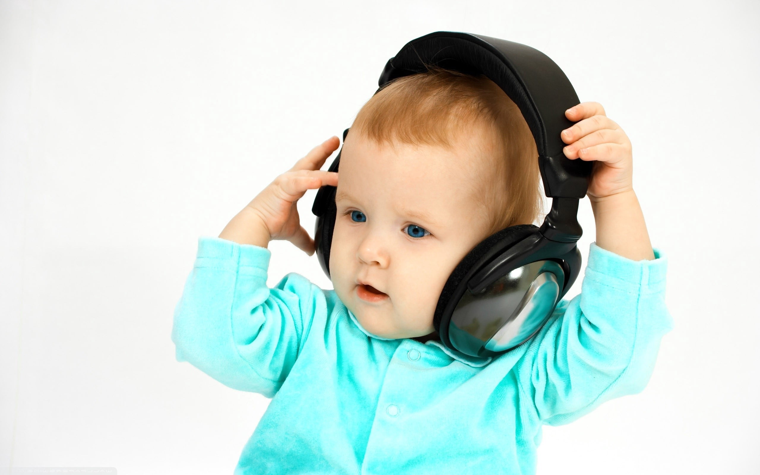 black wireless headphones and baby's teal jacket, child, face