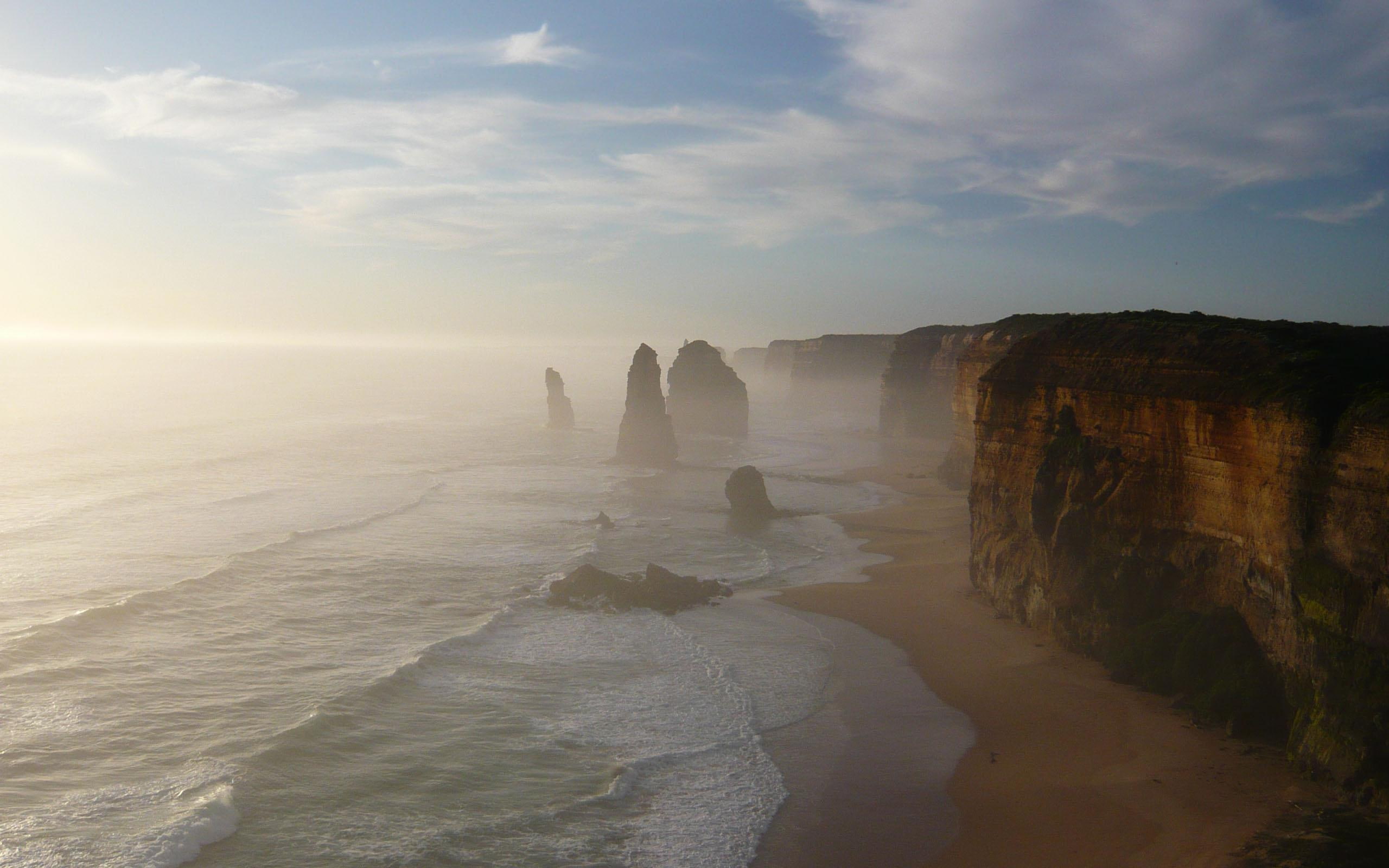 The Twelve Apostles, brown cliff near body of ocean, beach, mist