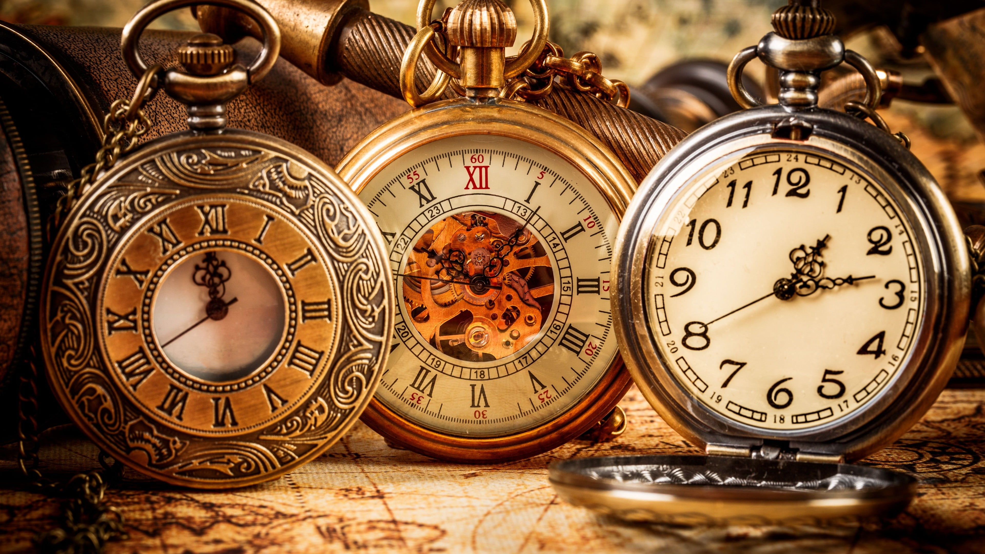 three silver-colored and gold-colored pocket watches, clocks