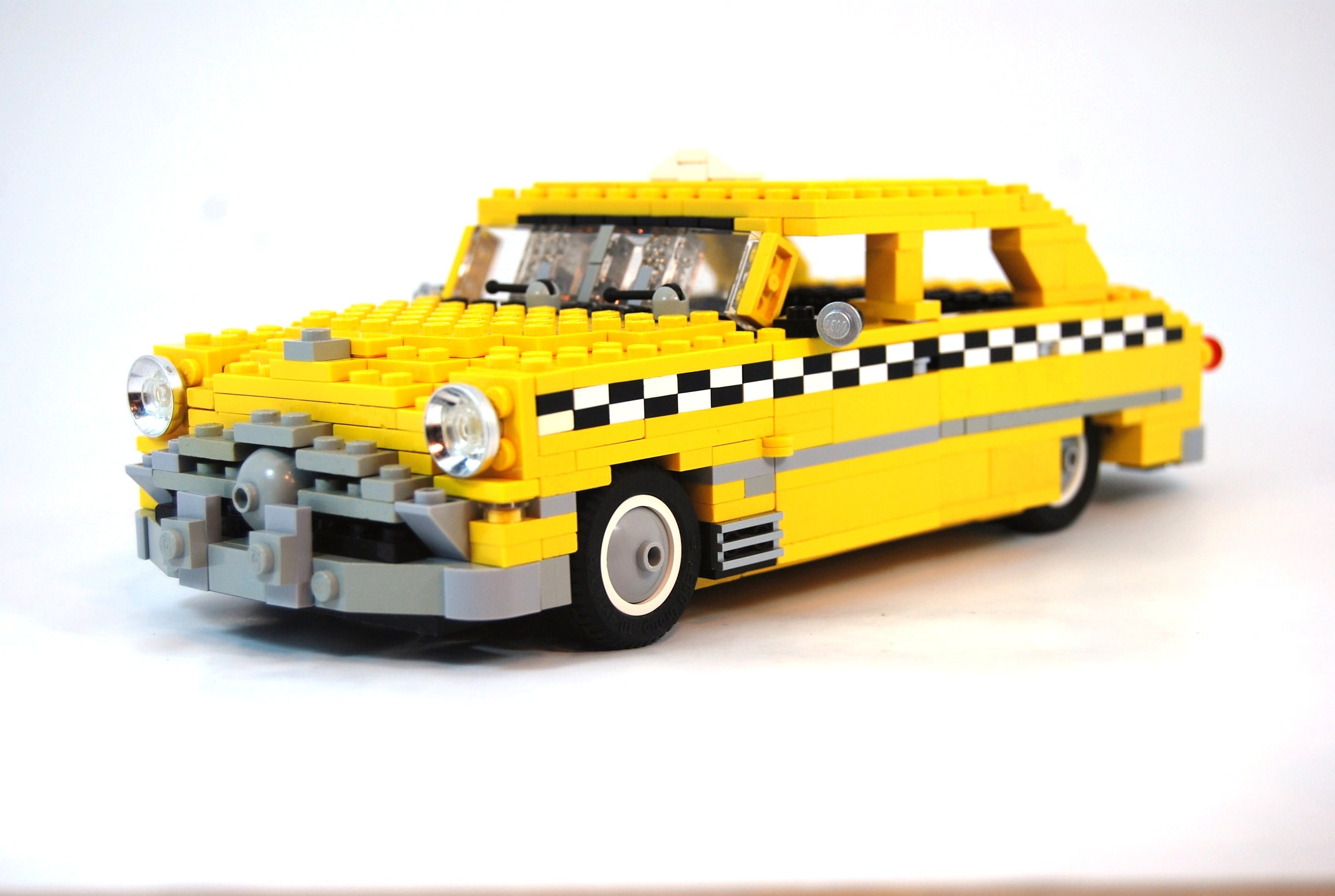 Lego Taxi puzzle toy, car, white background, yellow cars, checkered