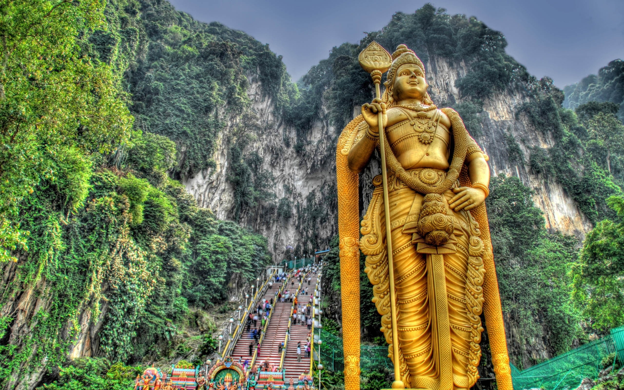 gold Hindu god statue, murugan, malaysia, stairs, hills, people