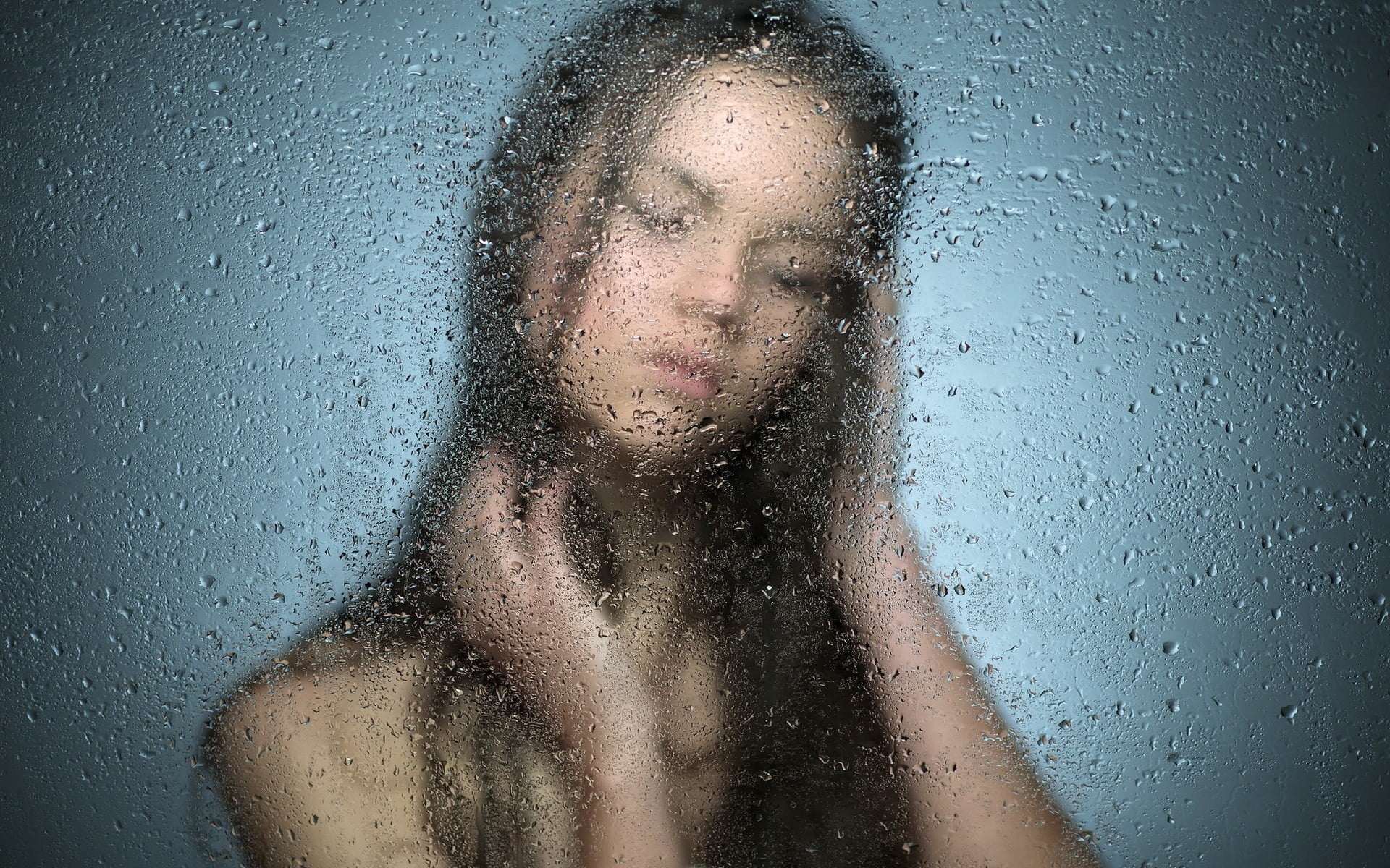 women's black hair, woman behind frost glass, wet, blurred, nude