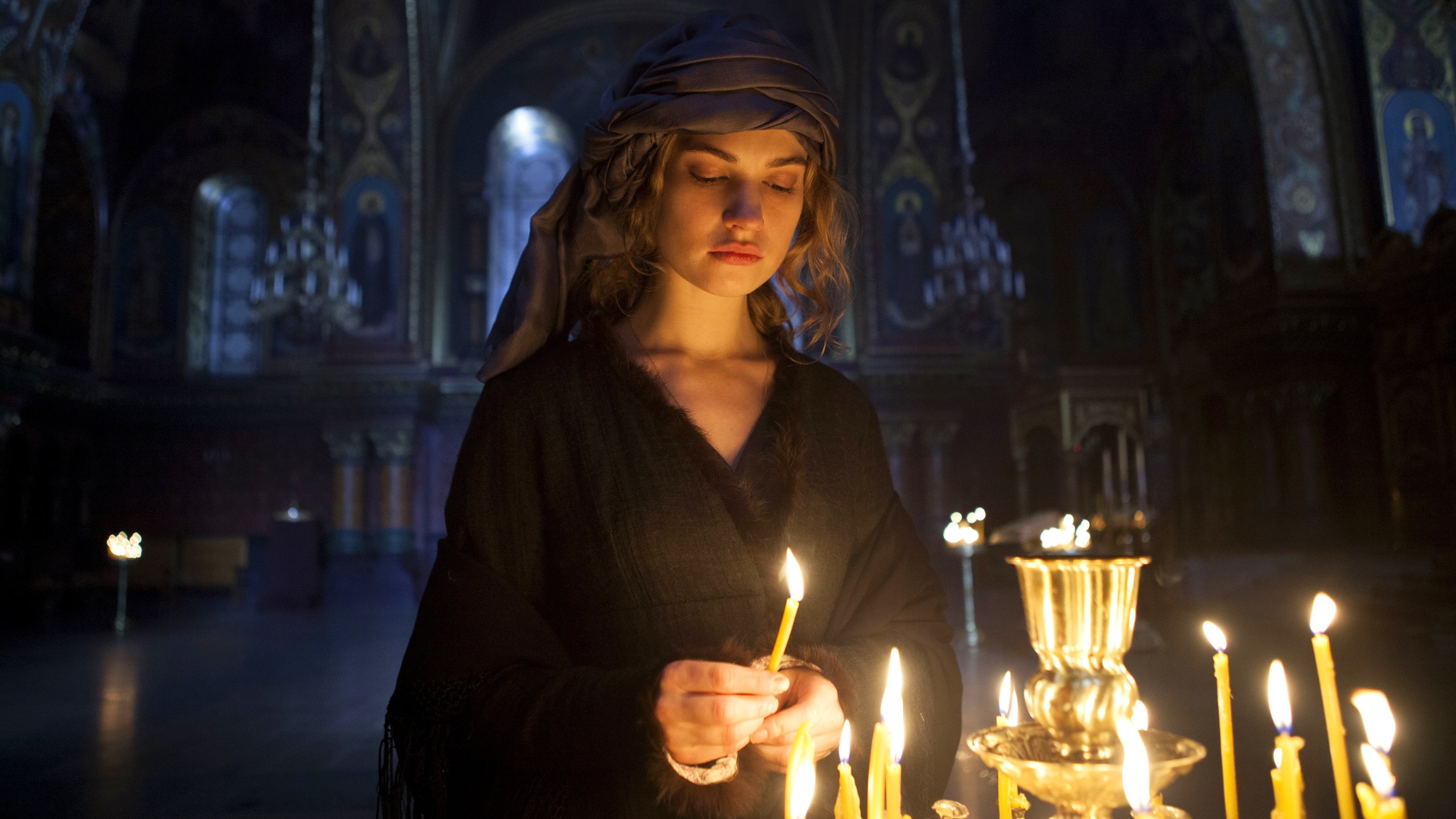 woman wearing black holding candle, War & Peace, Lily James