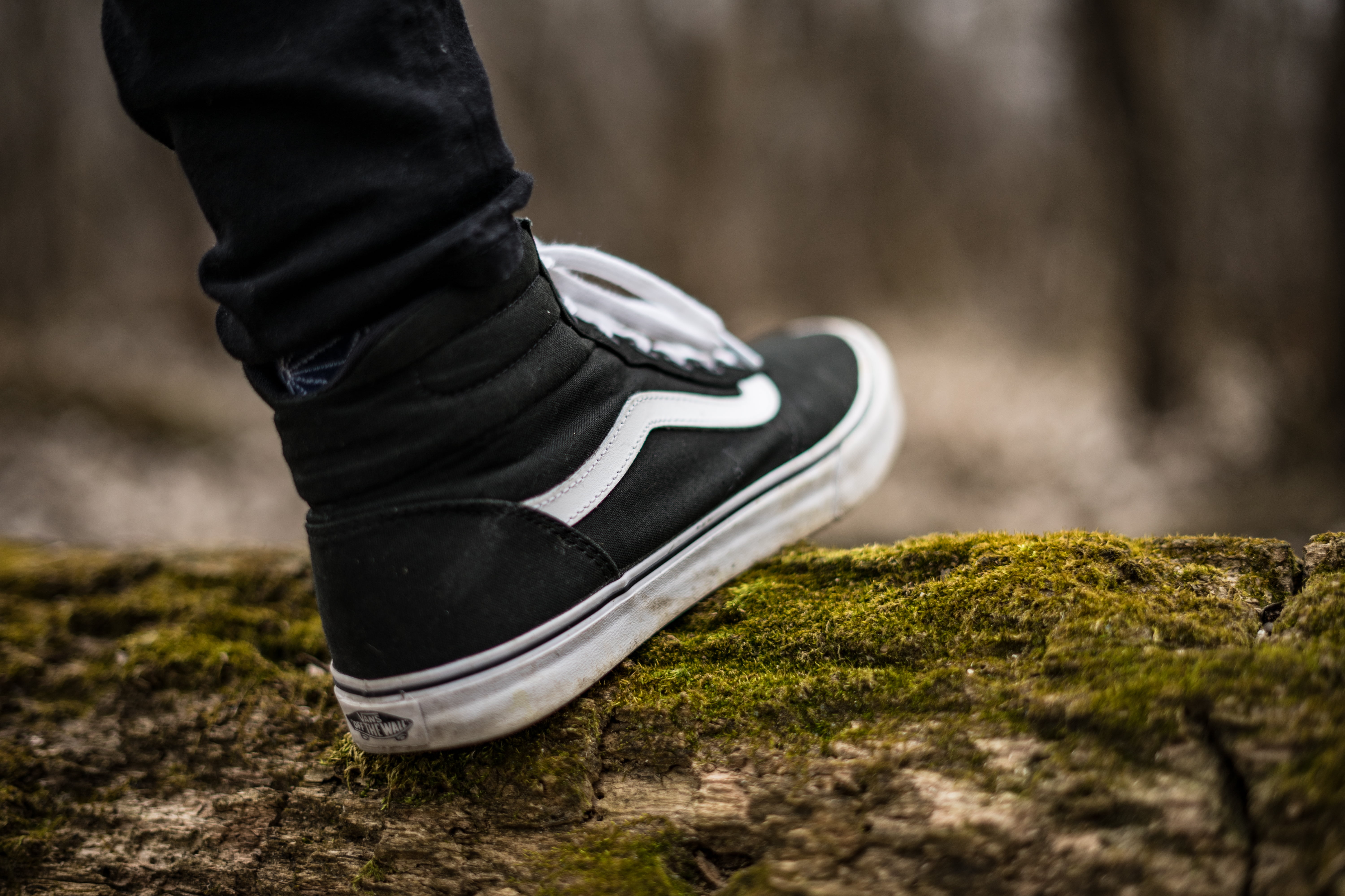 unpaired black and white Vans Sk8-Hi, sneakers, shoes, legs, outdoors