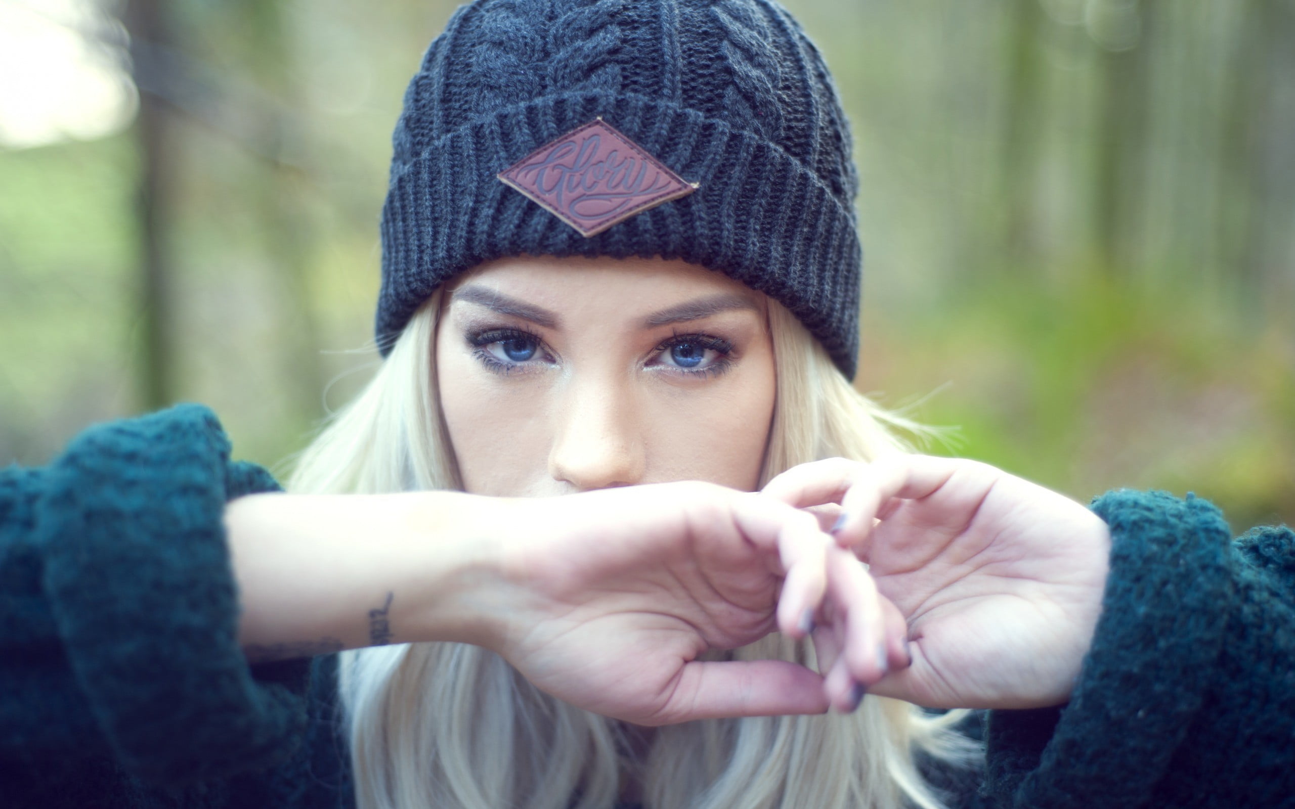 women's black sweater and gray bobble hat, Amy Crilley, blonde