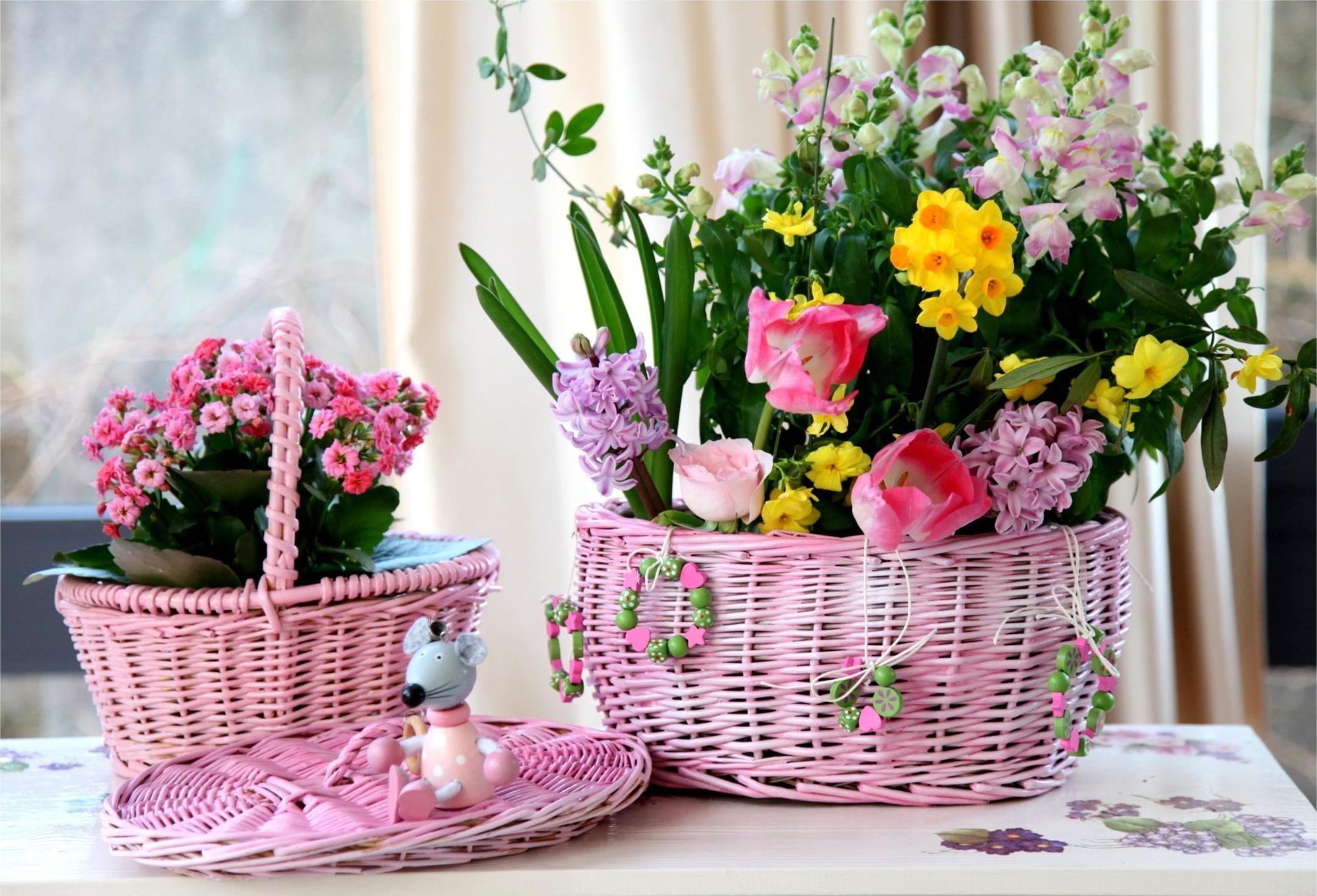 two pink wicker baskets, roses, hyacinths, daffodils, tulips