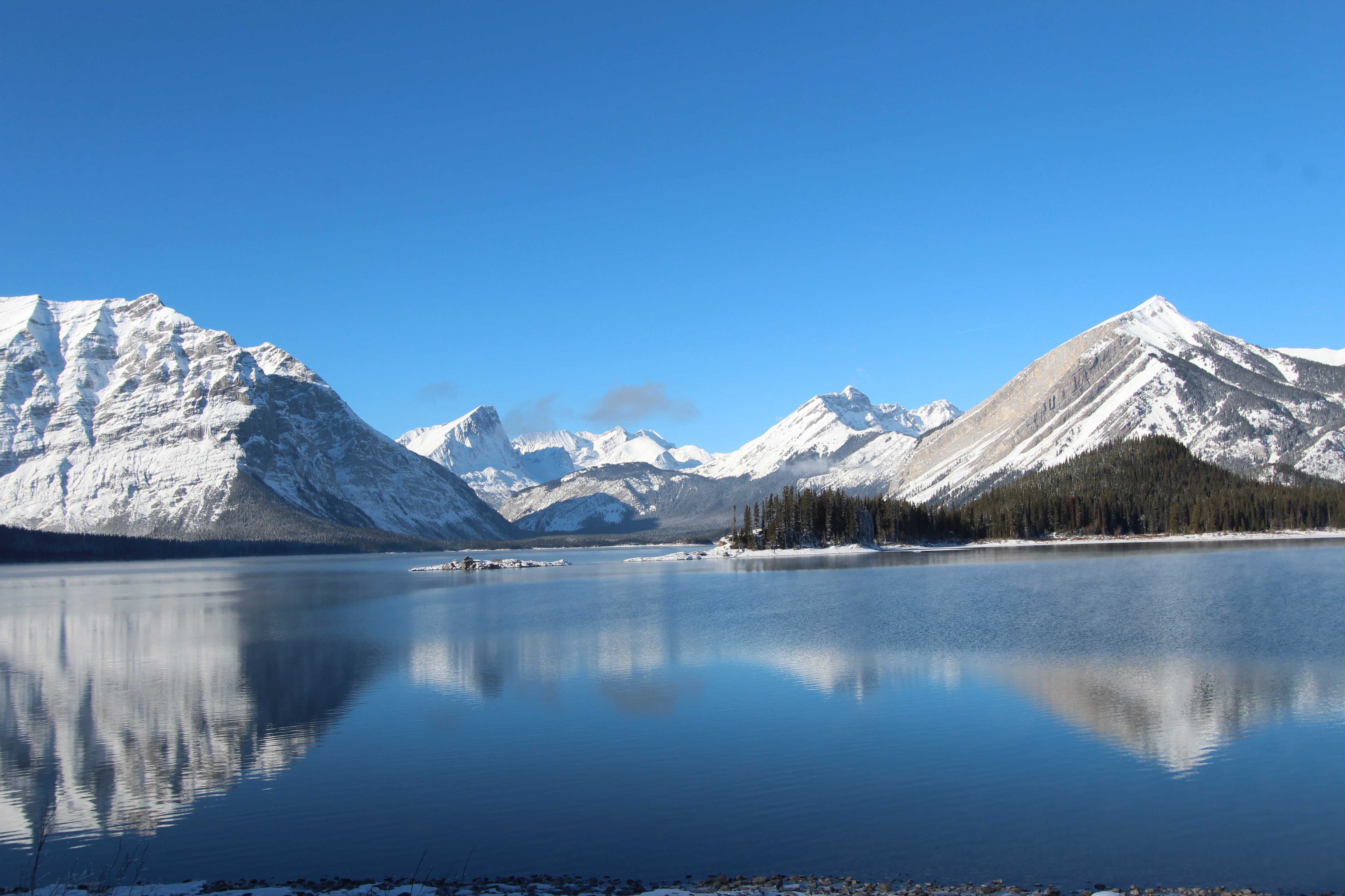 snow covered mountains near body of water during daytime, upper kananaskis lake, canada, upper kananaskis lake, canada