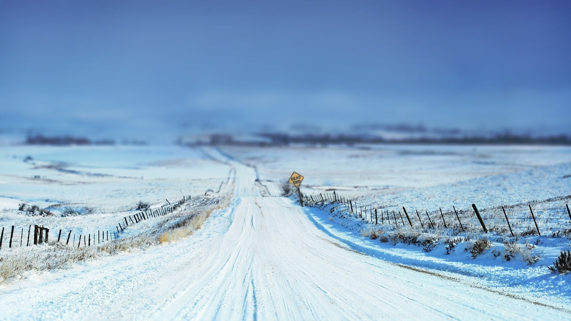 dirt road covered by snow, tilt shift, winter, signs, fence, landscape