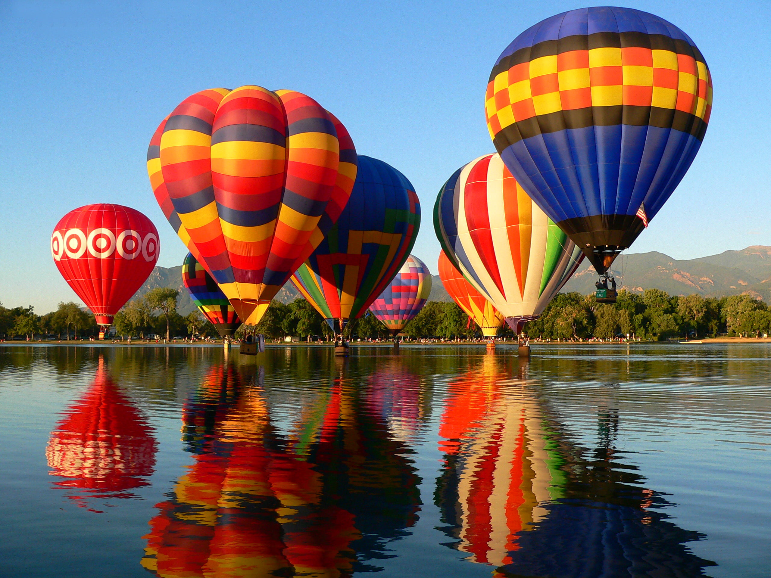 eight assorted-color hot air balloons, the sky, trees, mountains