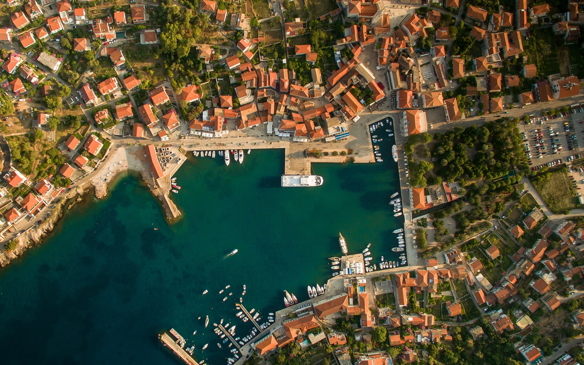 aerial view of body of water between cities, aerial view of body of water surrounded by buildings