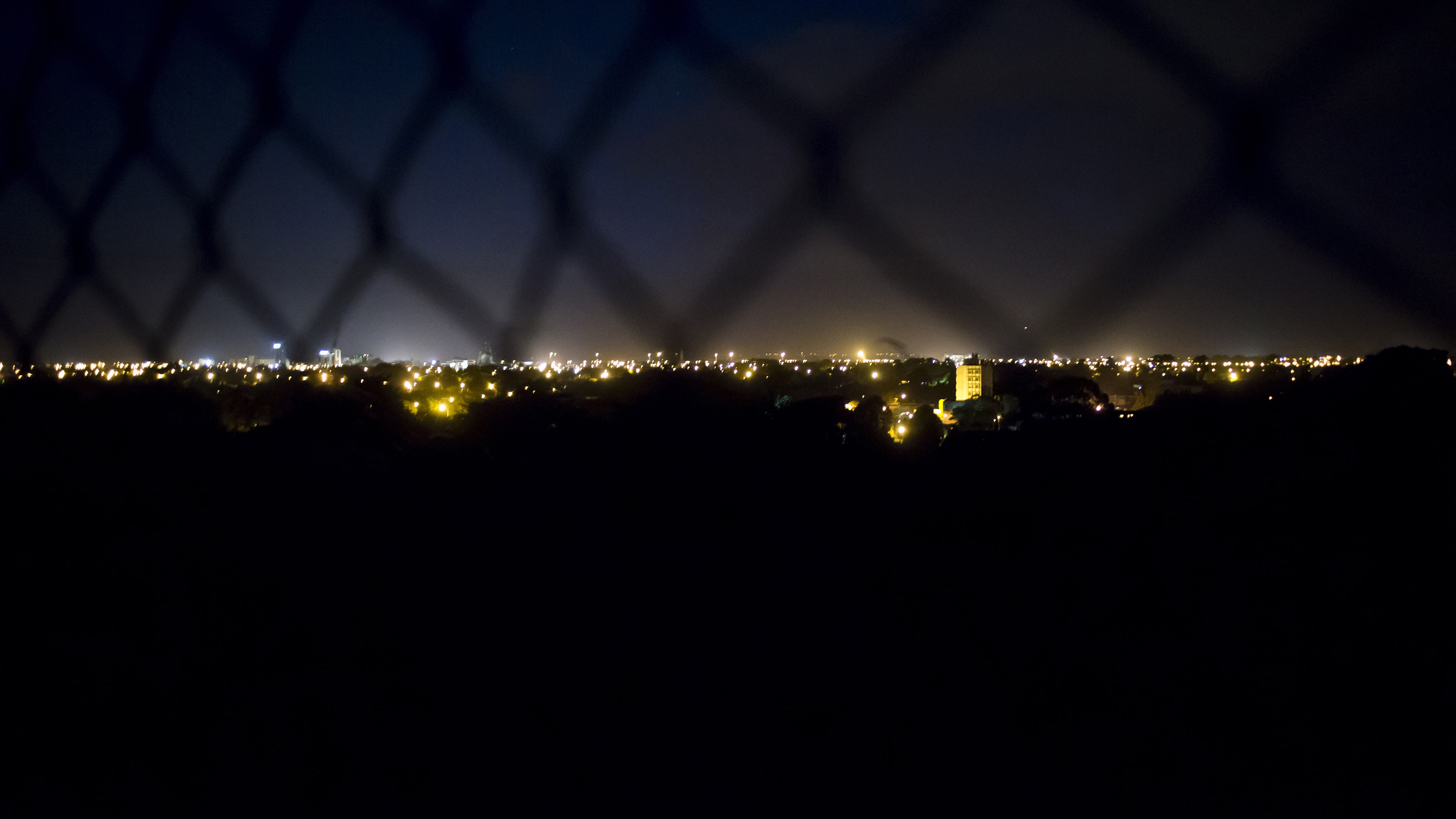cityscape, fence, night, city lights, illuminated, sky, no people