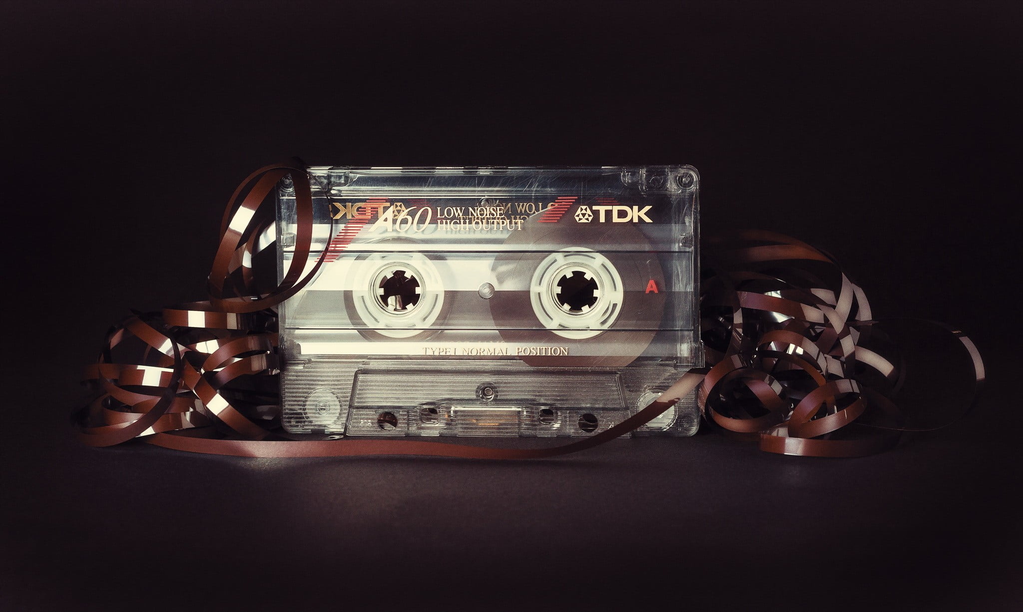selective focus photo of TDK cassette, tape, music, black background