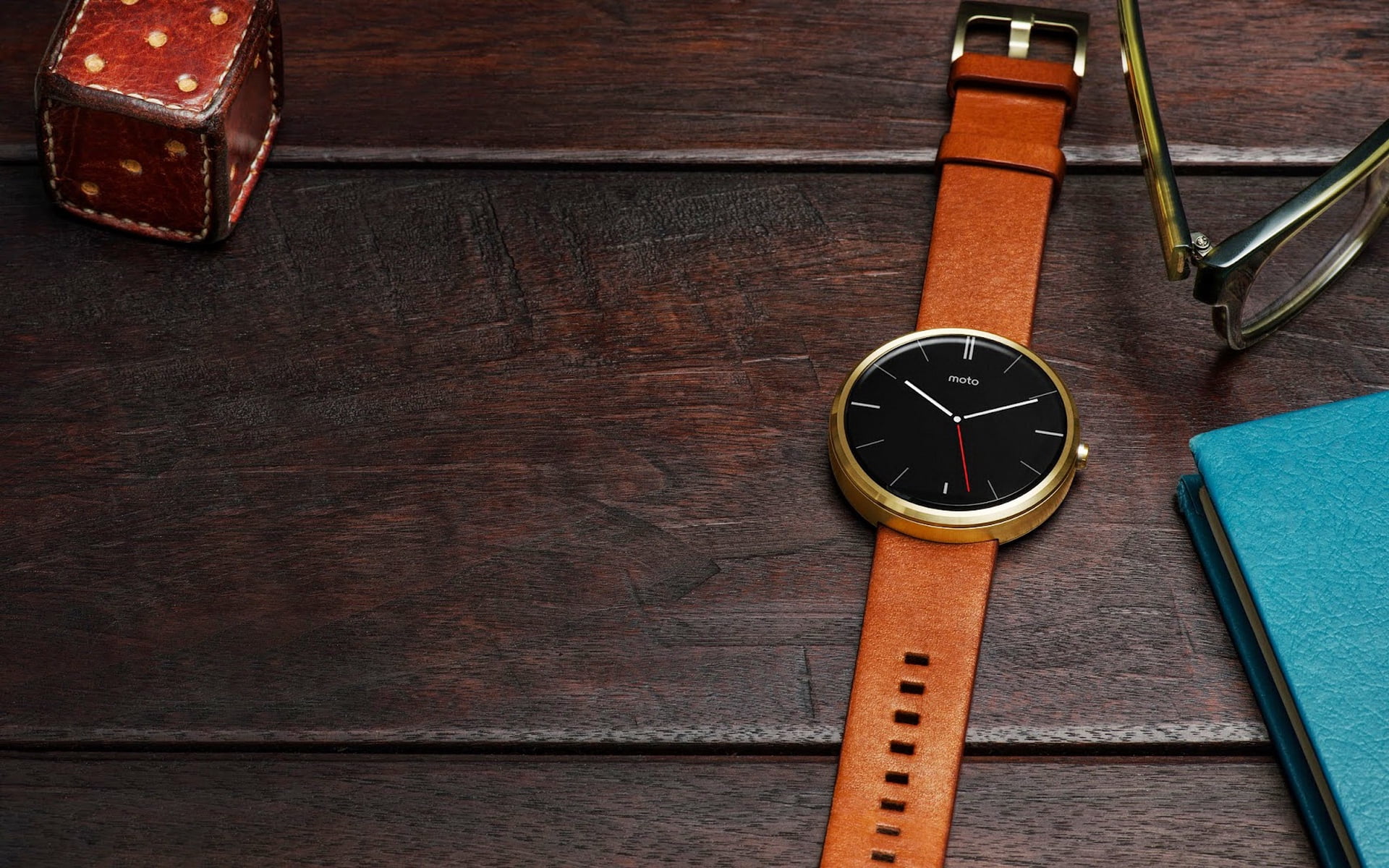gold-colored analog watch with brown leather strap, motorola